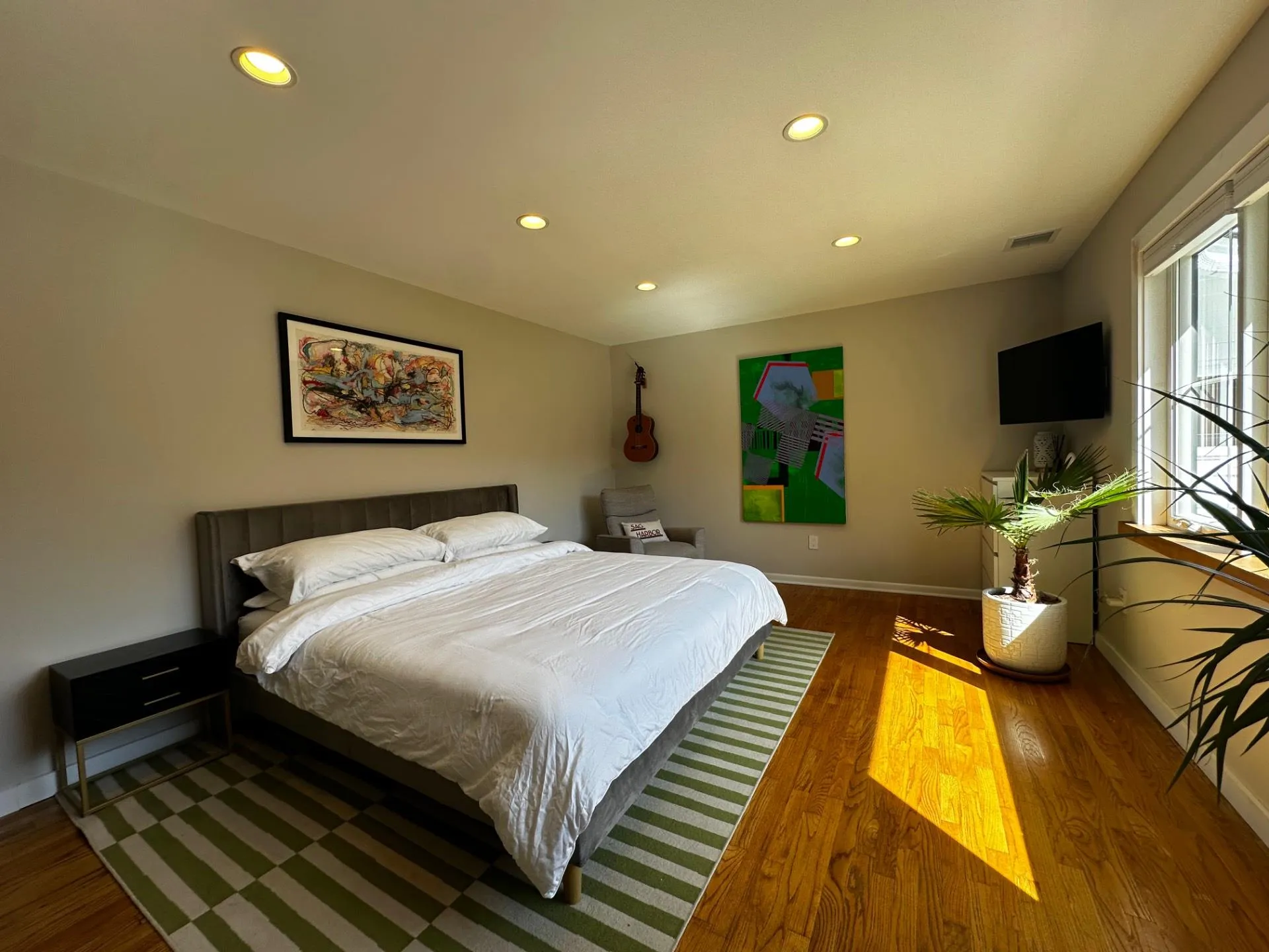 Bedroom featuring wood finished floors, recessed lighting, and visible vents Bedroom featuring wood finished floors, recessed lighting, and visible vents