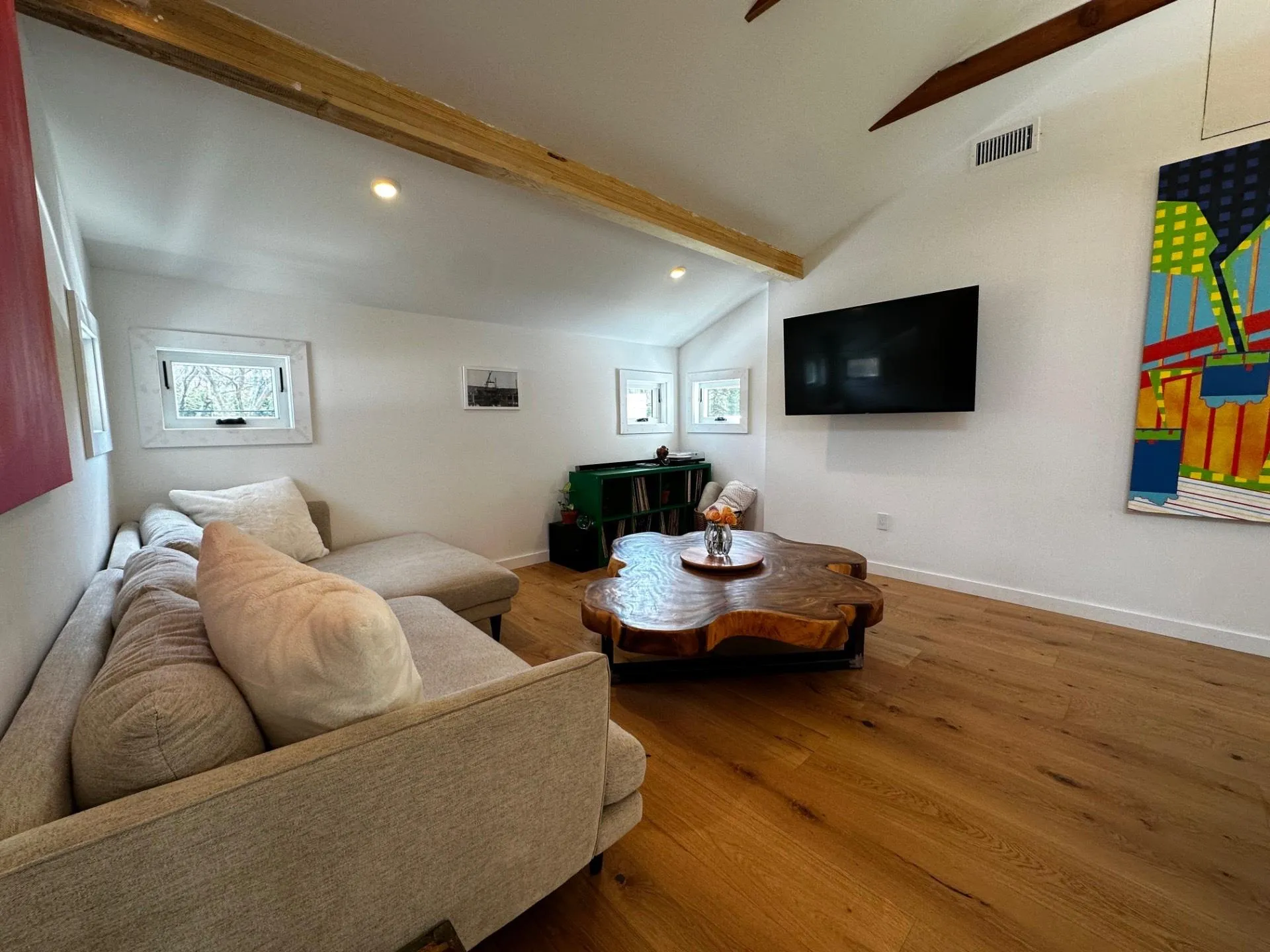 Living area with lofted ceiling with beams, wood finished floors, baseboards, visible vents, and recessed lighting Living area with lofted ceiling with beams, wood finished floors, baseboards, visible vents, and recessed lighting