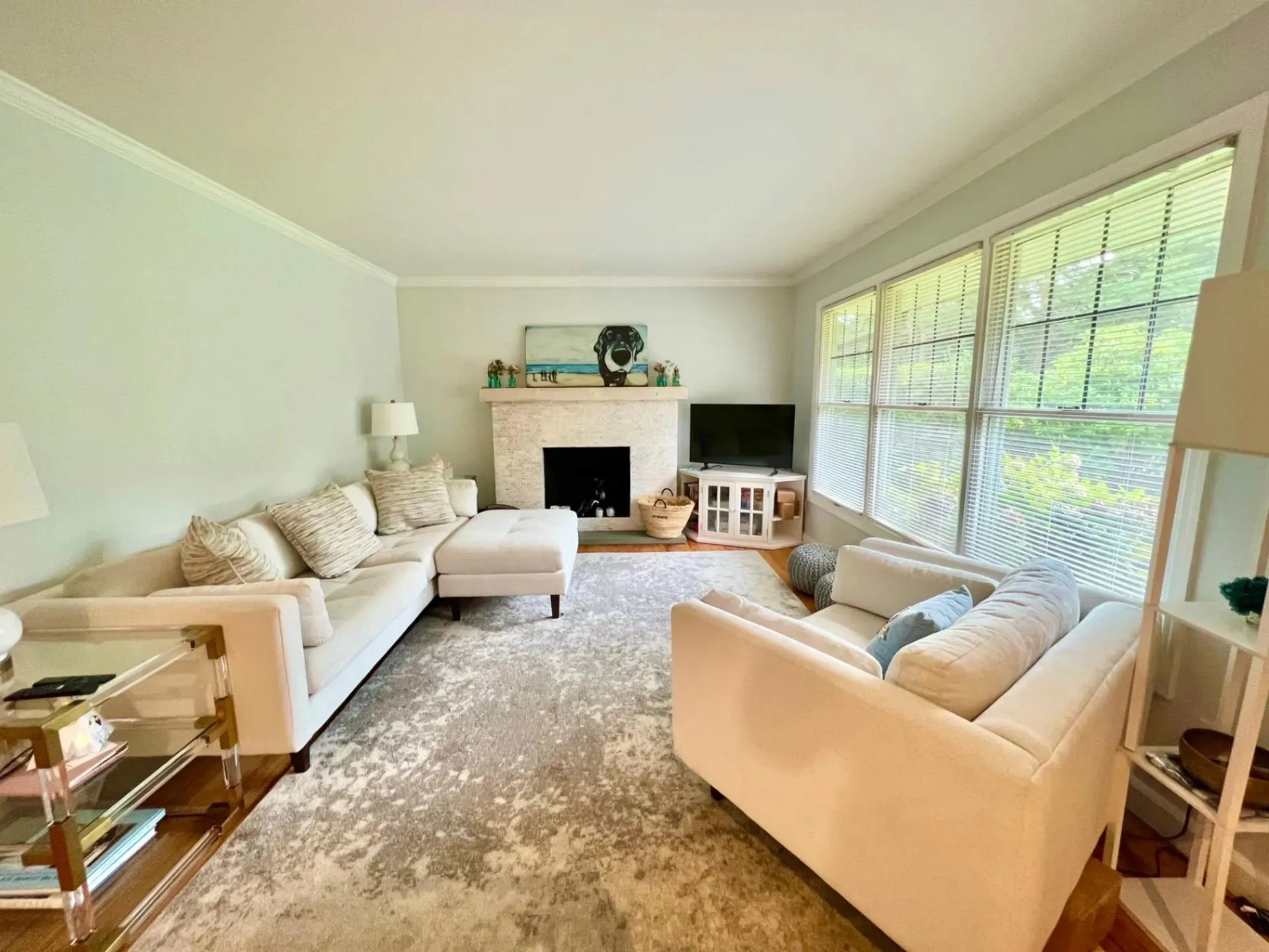 Living room featuring ornamental molding, a fireplace, and wood finished floors Living room featuring ornamental molding, a fireplace, and wood finished floors