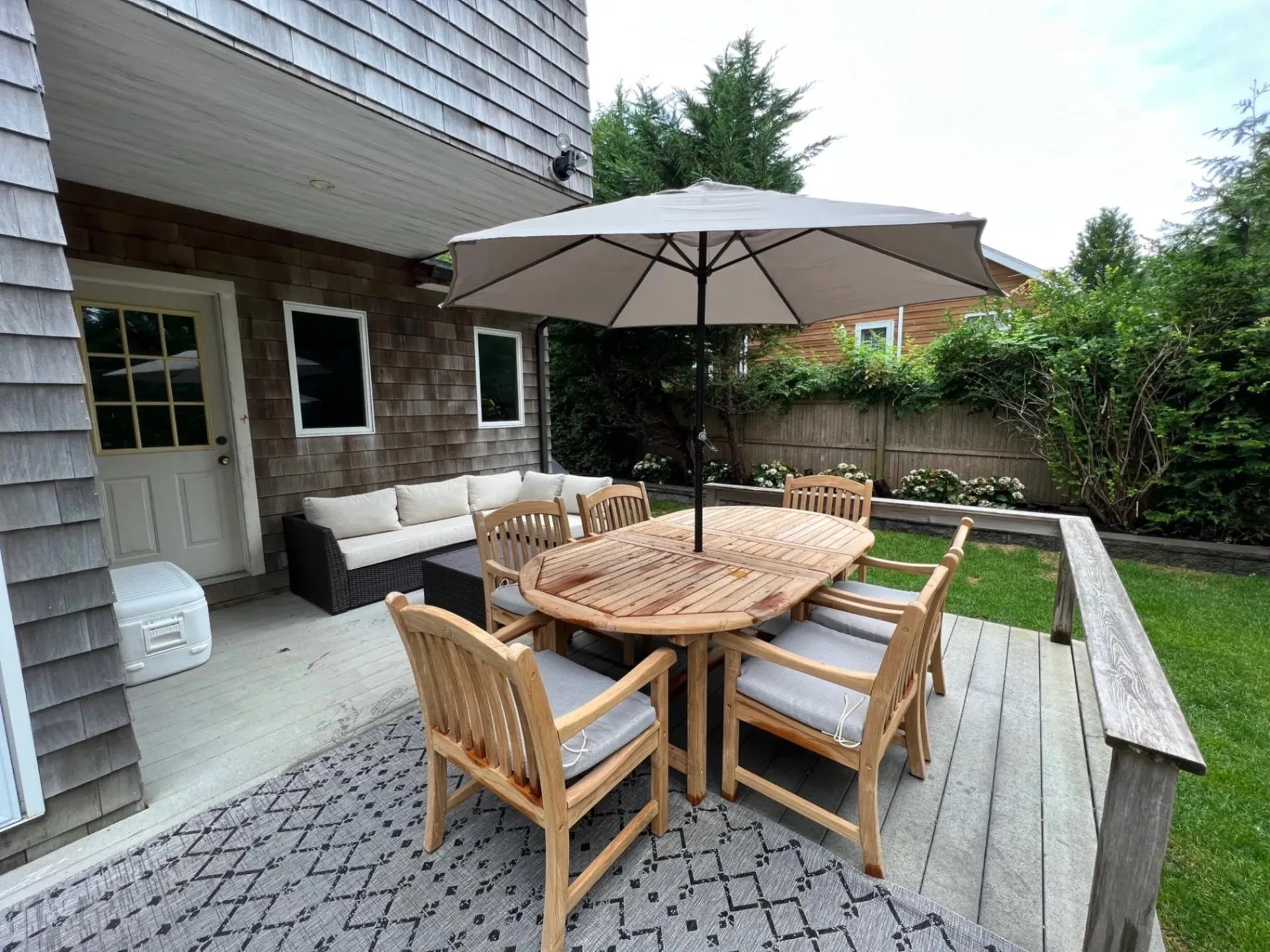 Wooden terrace featuring an outdoor hangout area, fence, and outdoor dining space Wooden terrace featuring an outdoor hangout area, fence, and outdoor dining space