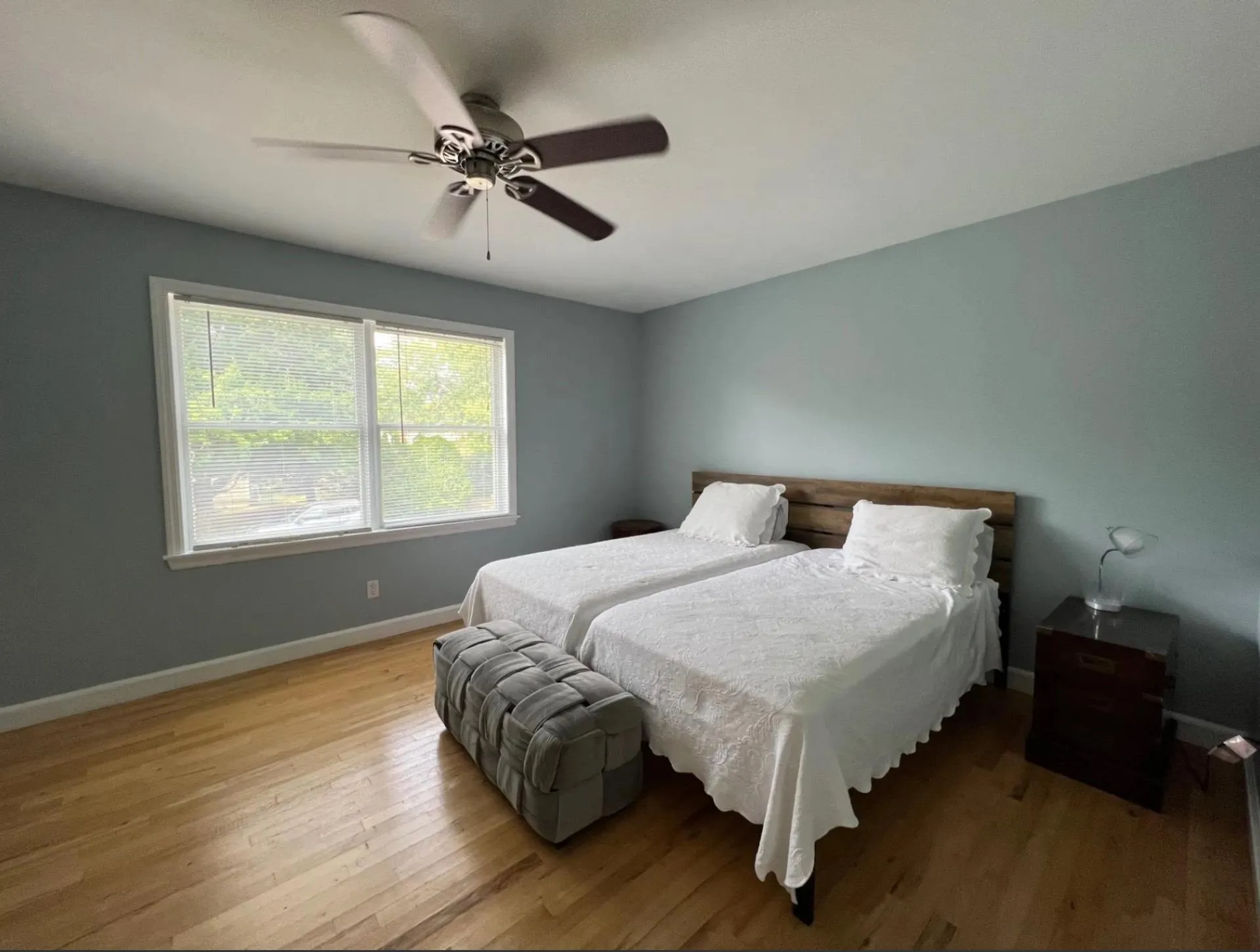 Bedroom featuring a ceiling fan, baseboards, and wood finished floors Bedroom featuring a ceiling fan, baseboards, and wood finished floors