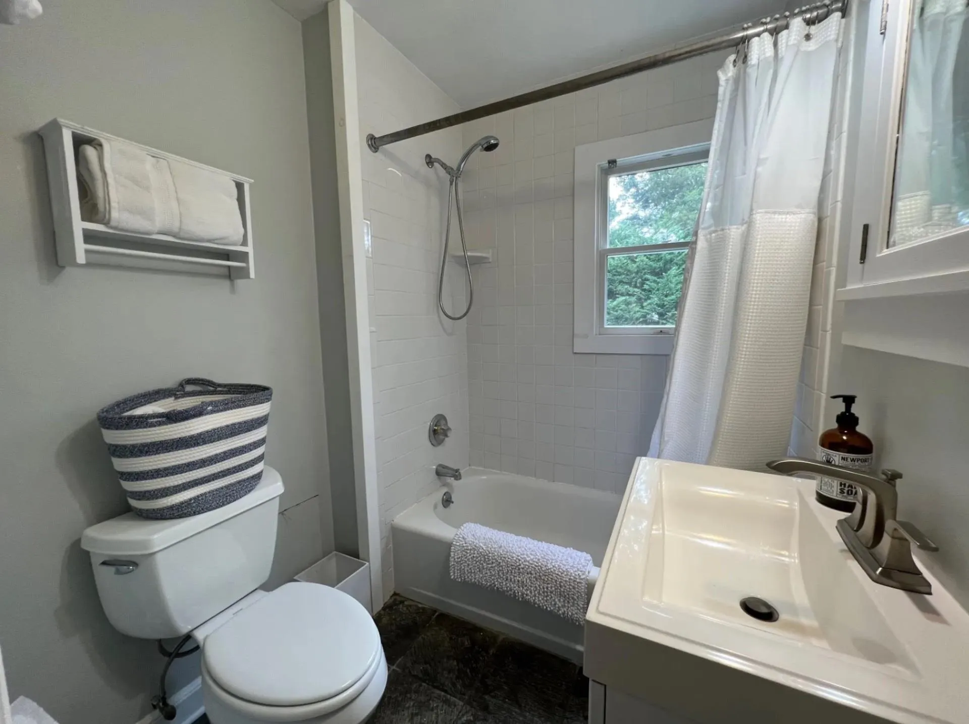 Bathroom with toilet, shower / tub combo with curtain, and vanity Bathroom with toilet, shower / tub combo with curtain, and vanity