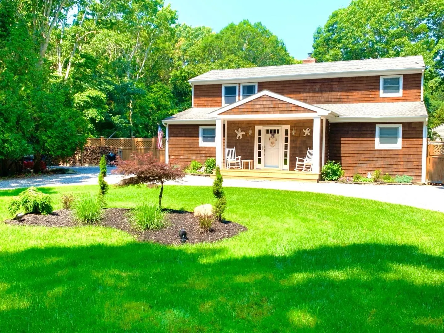 View of front of property with fence, a chimney, a front yard, a shingled roof, and a porch View of front of property with fence, a chimney, a front yard, a shingled roof, and a porch