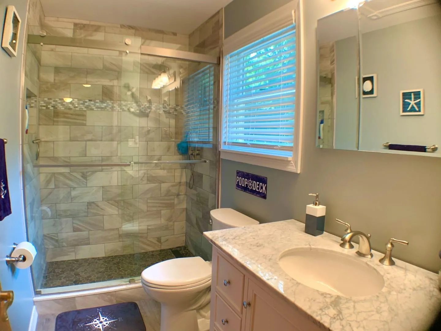 Full bath with a shower stall, toilet, and vanity Full bath with a shower stall, toilet, and vanity
