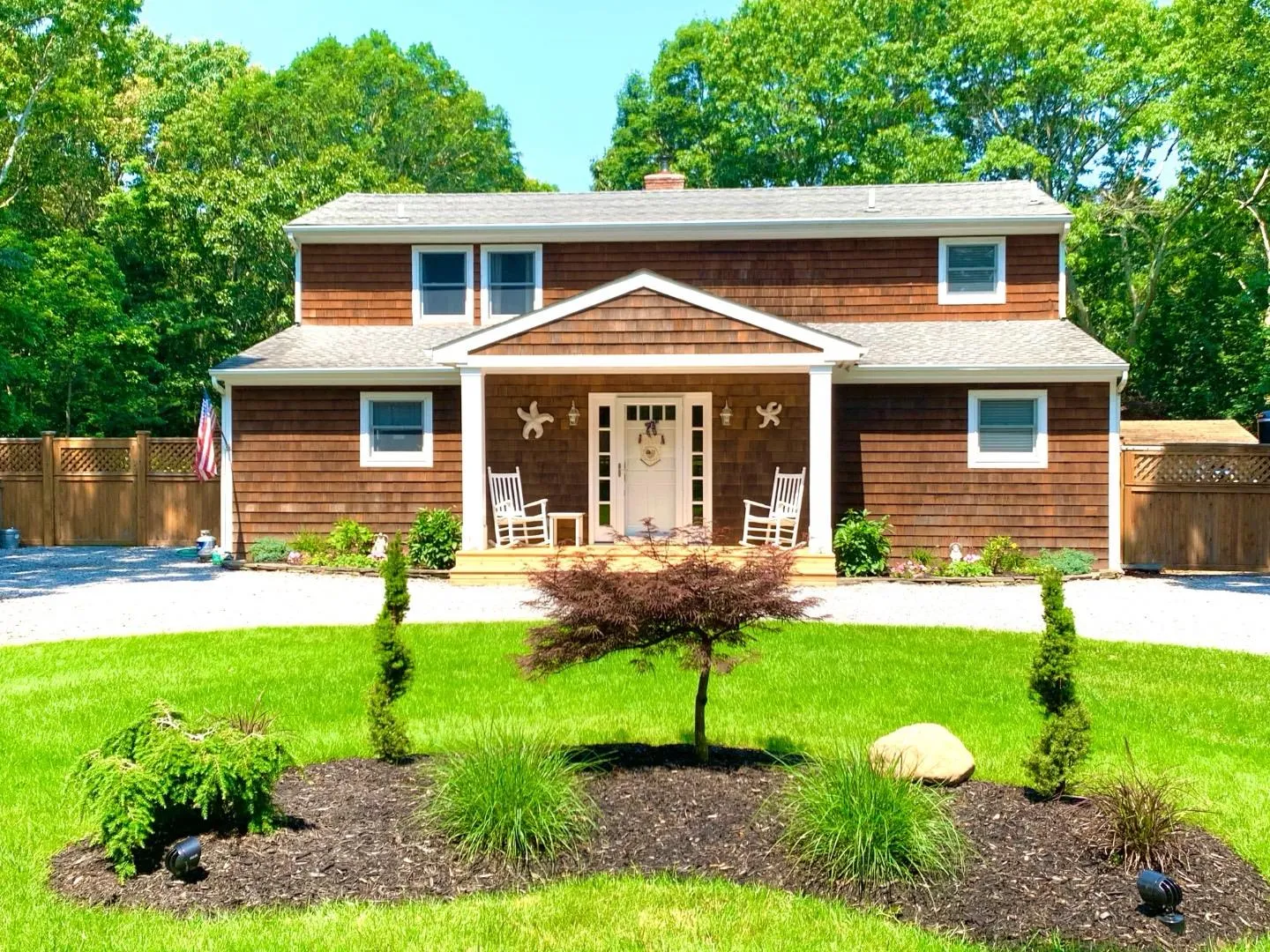 View of front of property featuring a chimney, fence, and a front yard View of front of property featuring a chimney, fence, and a front yard