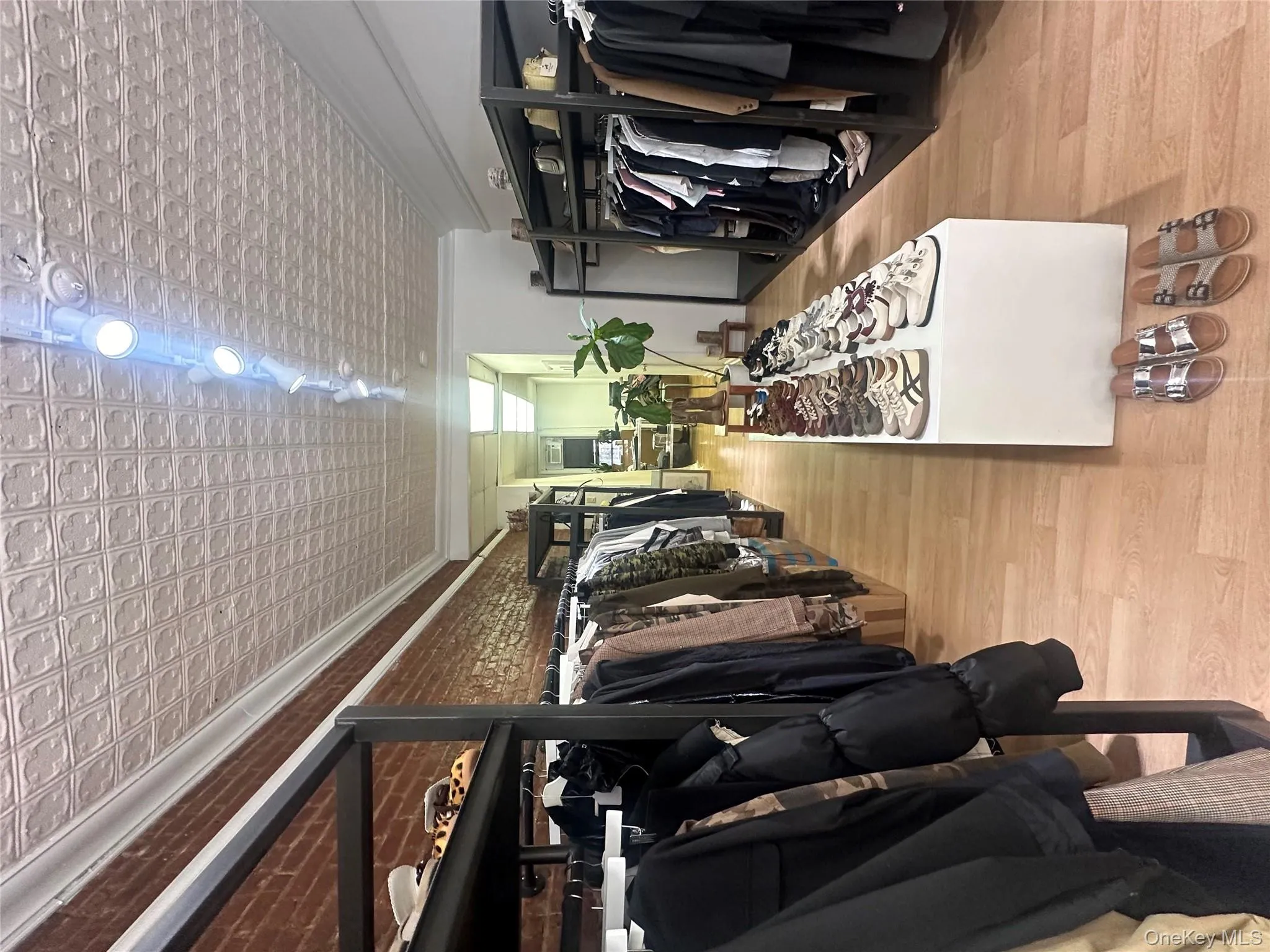 Walk in closet featuring wood finished floors Walk in closet featuring wood finished floors