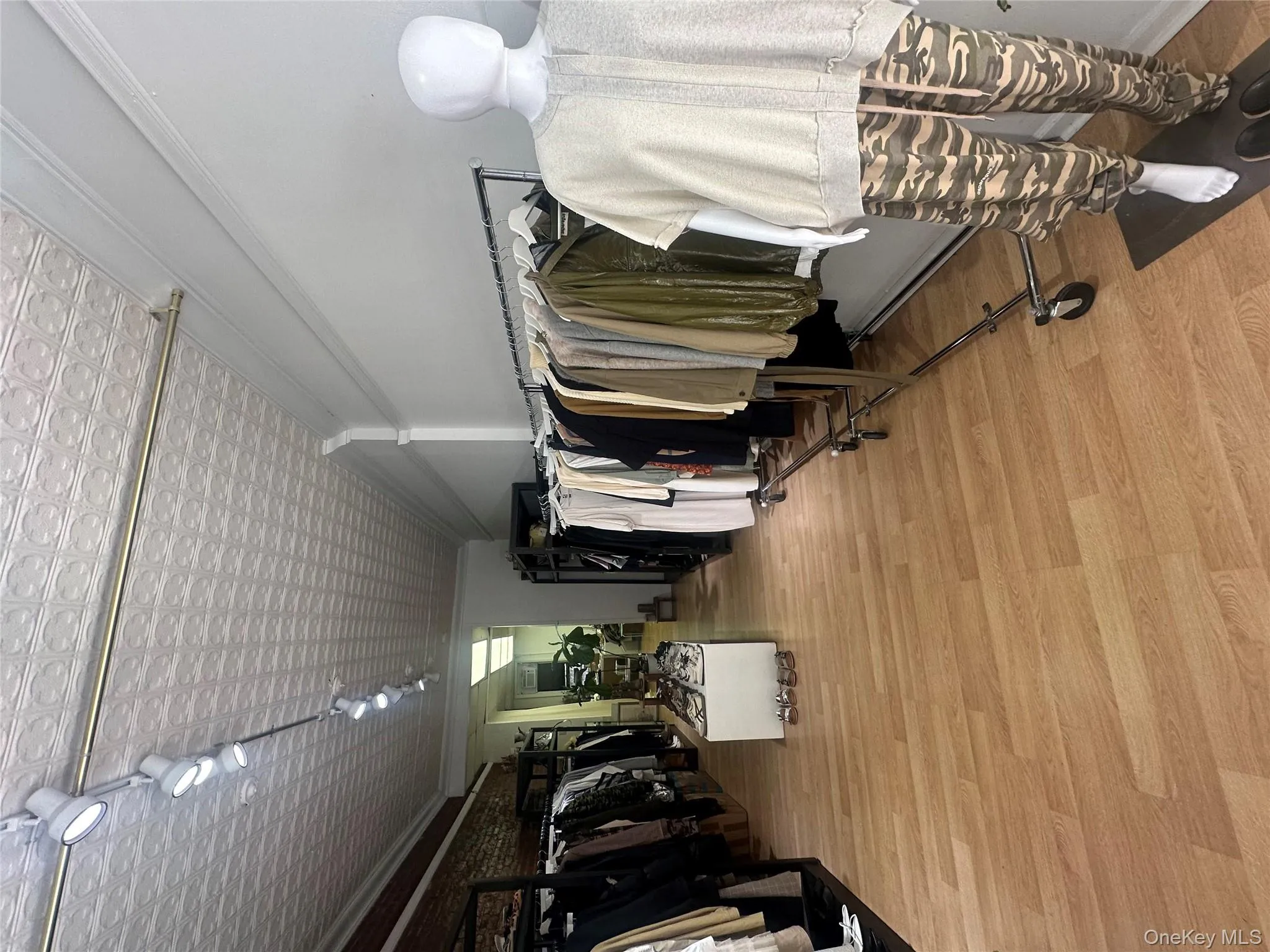 Spacious closet with light wood-style flooring Spacious closet with light wood-style flooring