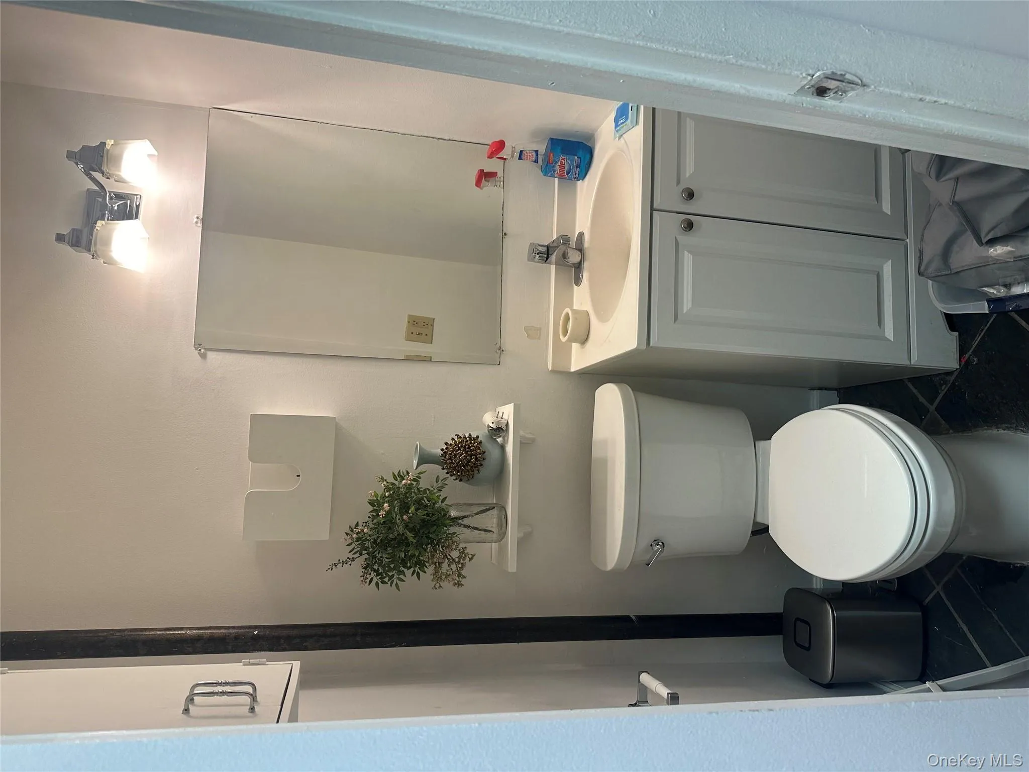 Half bathroom featuring toilet, tile patterned flooring, and vanity Half bathroom featuring toilet, tile patterned flooring, and vanity