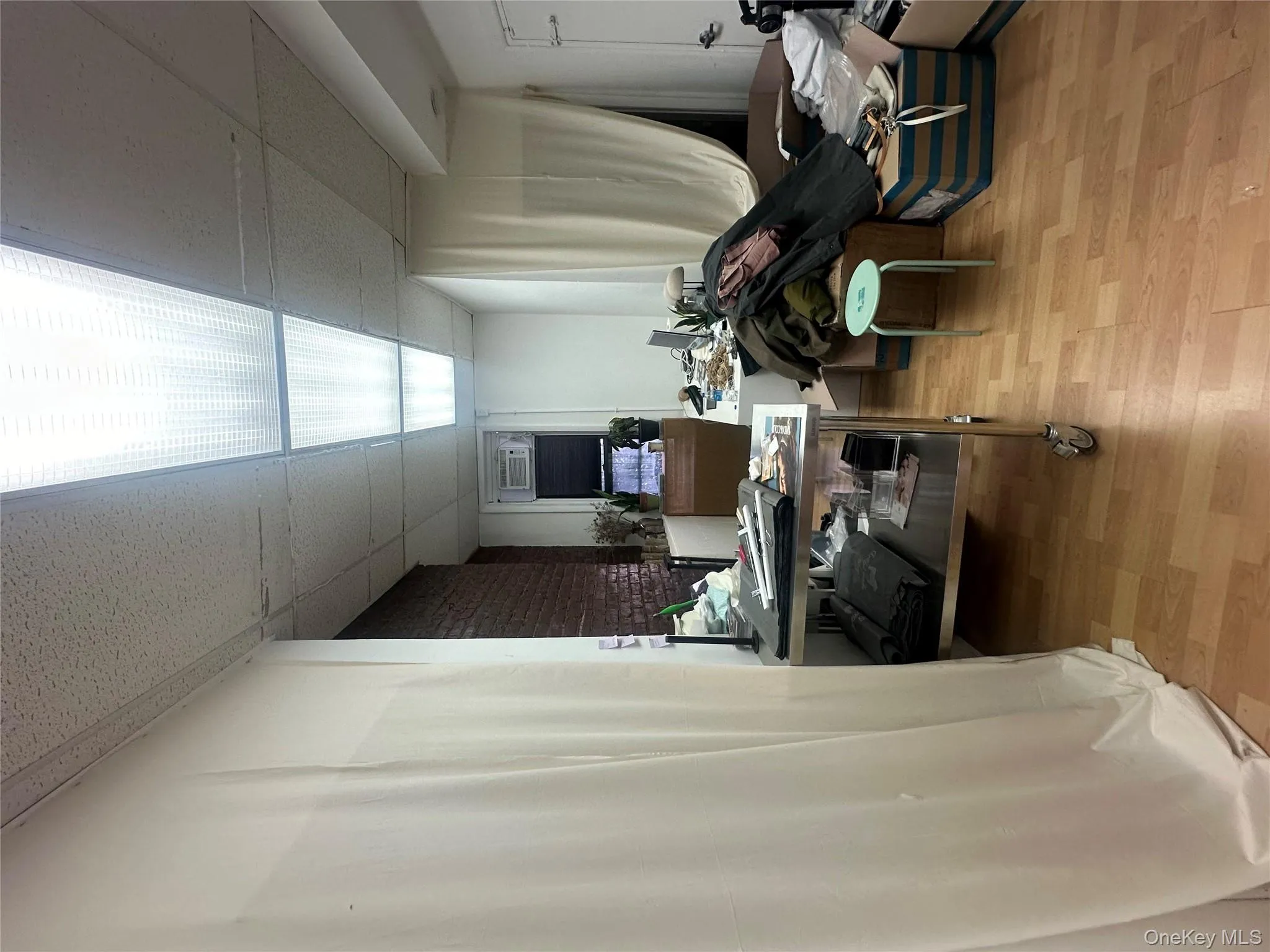 Office area with light wood finished floors and a paneled ceiling Office area with light wood finished floors and a paneled ceiling