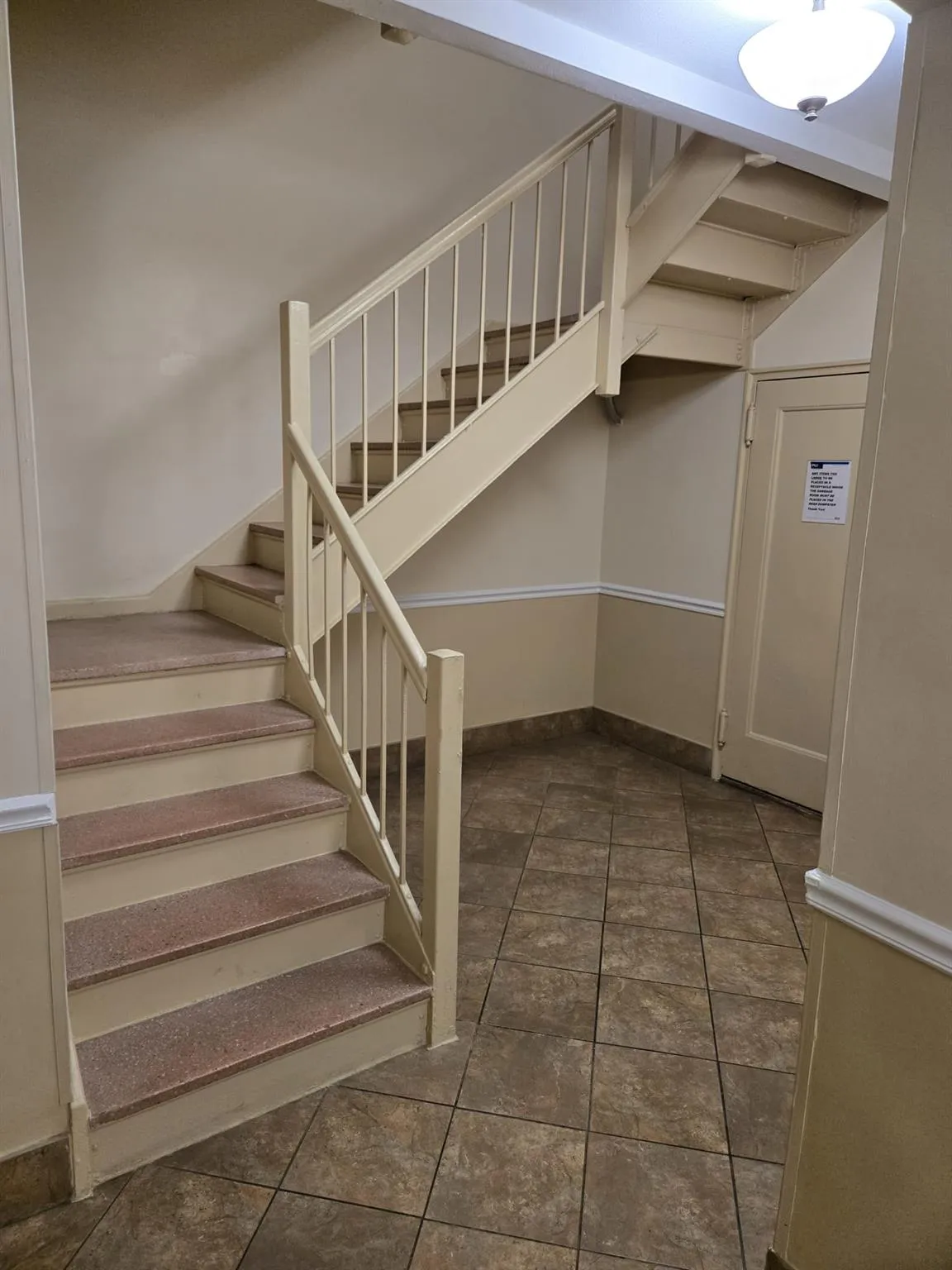 Stairs with baseboards and tile patterned floors Stairs with baseboards and tile patterned floors