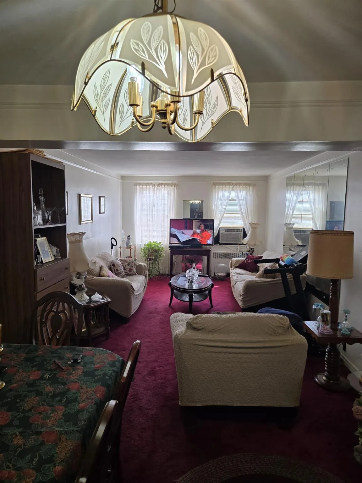 Living area with carpet flooring, an inviting chandelier, and a healthy amount of sunlight Living area with carpet flooring, an inviting chandelier, and a healthy amount of sunlight