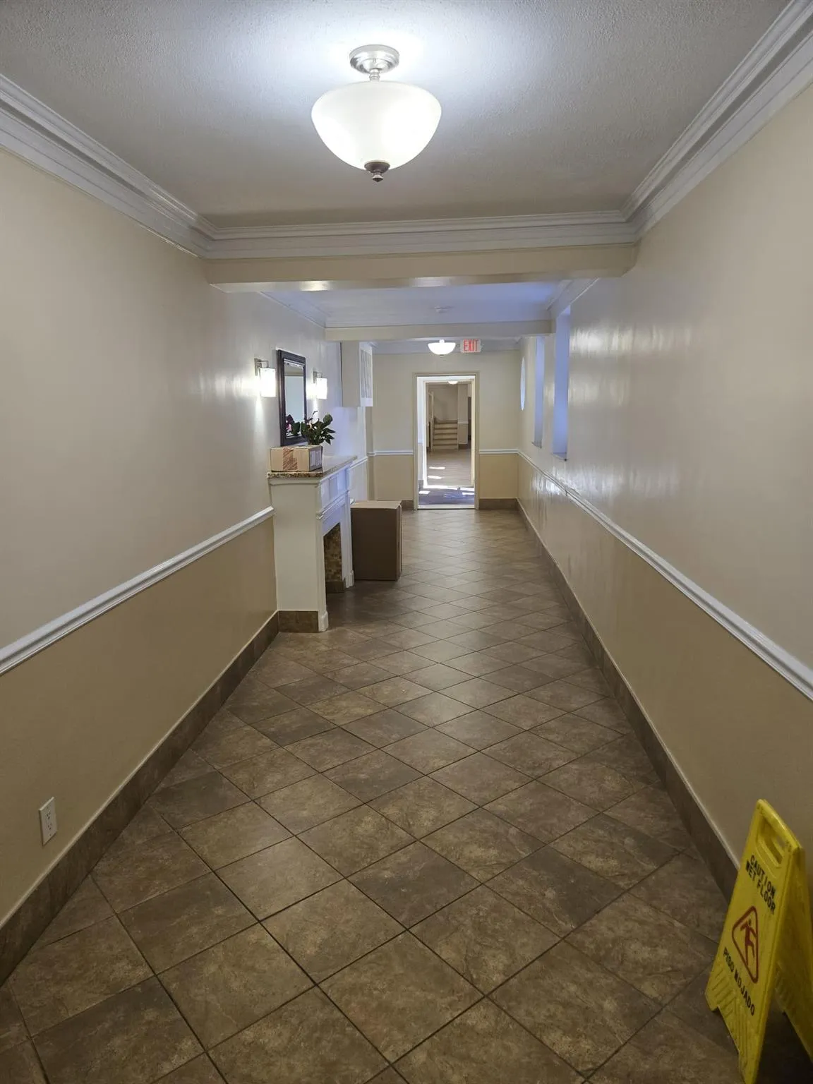 Hall featuring baseboards, crown molding, and a textured ceiling Hall featuring baseboards, crown molding, and a textured ceiling