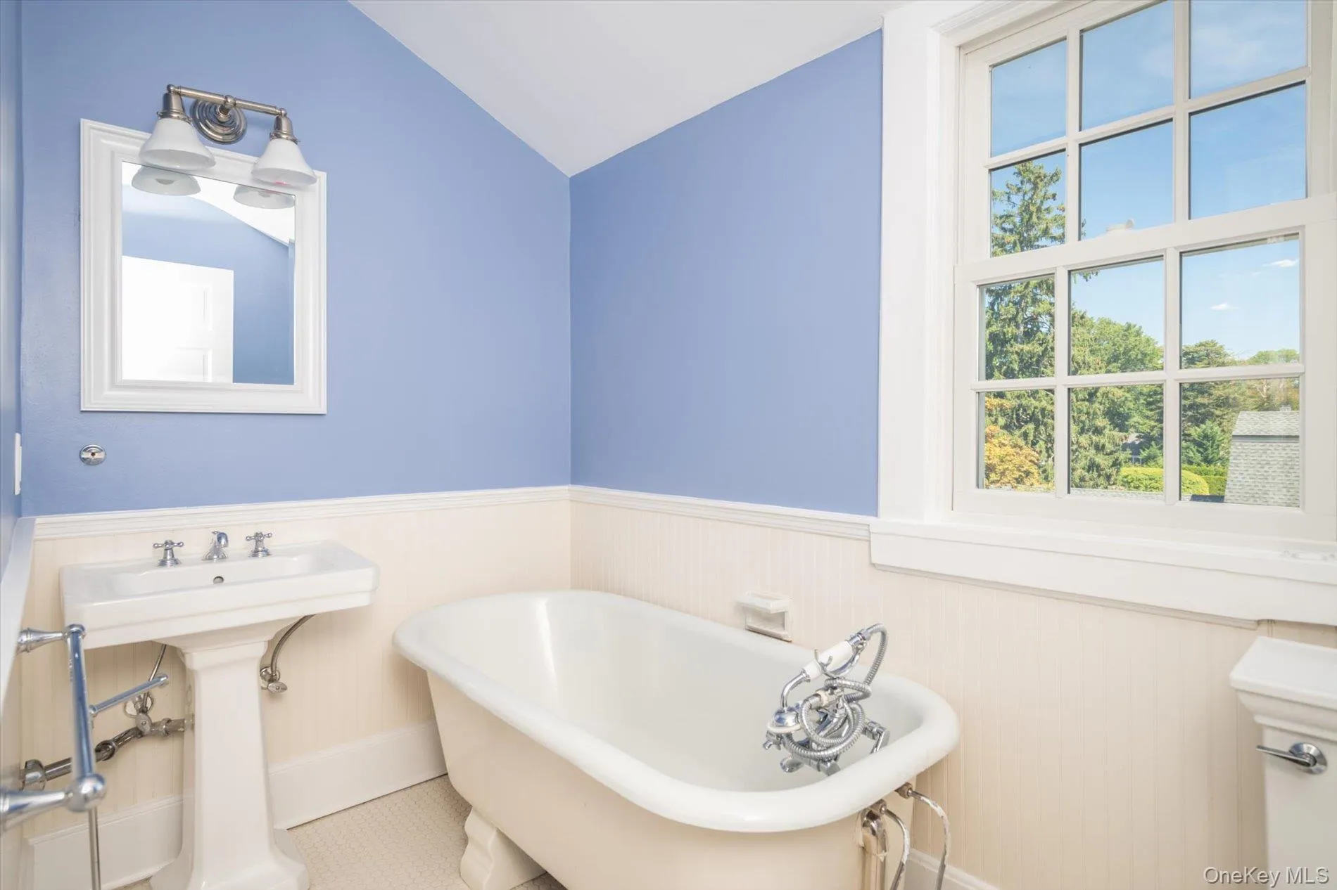 Bathroom with a soaking tub & accented with wainscoting Bathroom with a soaking tub & accented with wainscoting