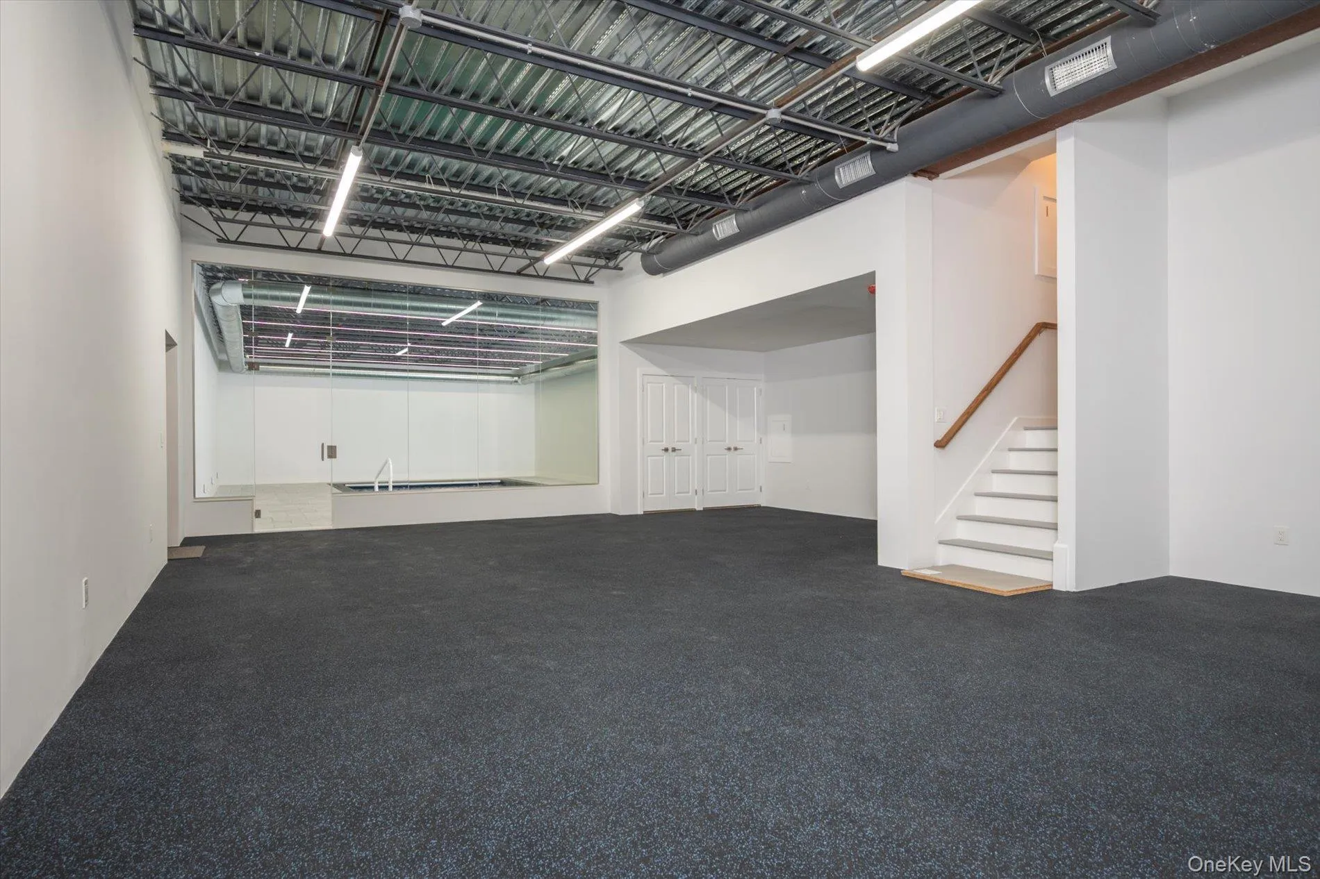 Fitness room/gym with his and hers full baths plus storage Fitness room/gym with his and hers full baths plus storage