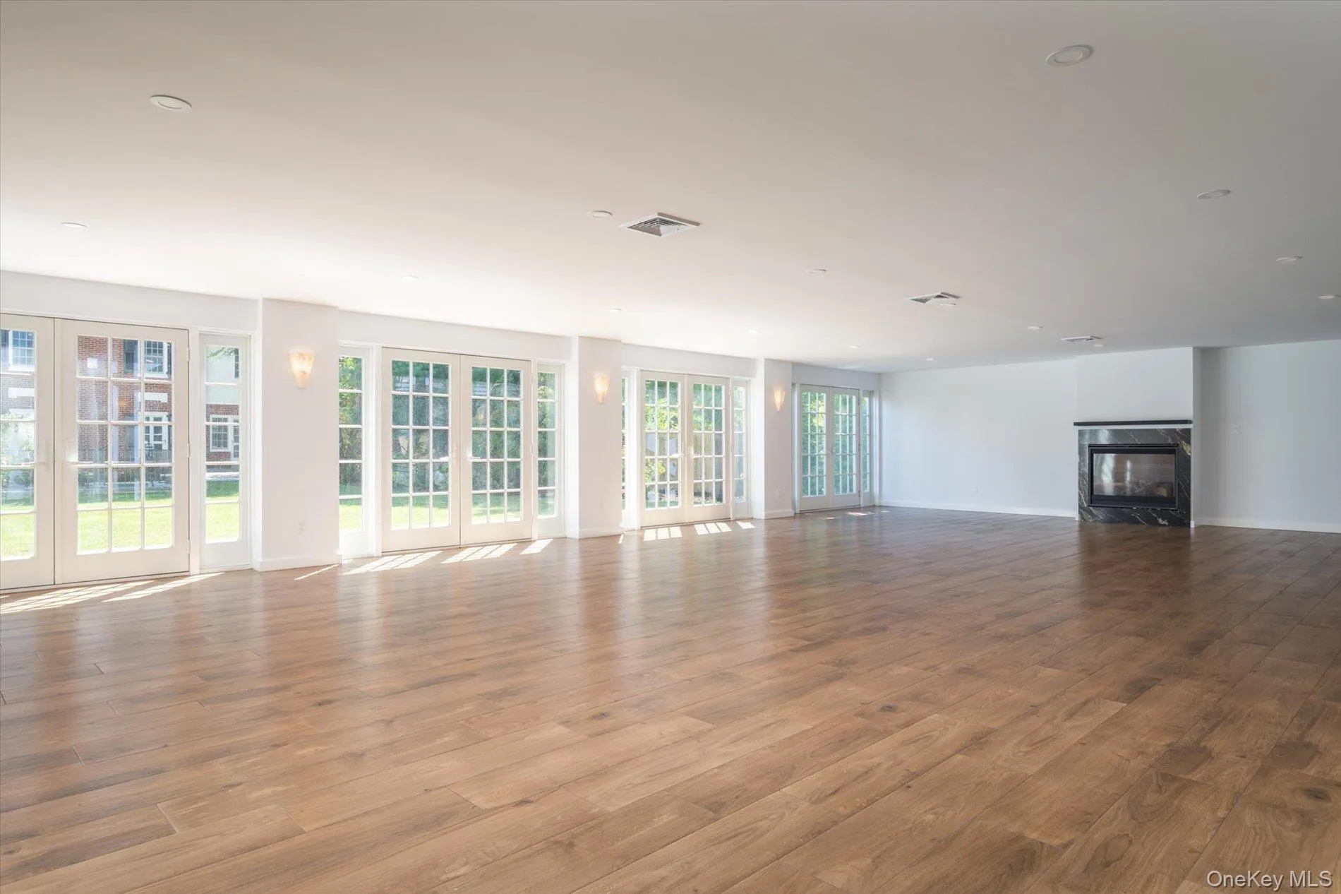 1305 sq ft terrace room featuring a gas fireplace and 4 sets of French doors overlooking the beautifully landscaped property 1305 sq ft terrace room featuring a gas fireplace and 4 sets of French doors overlooking the beautifully landscaped property