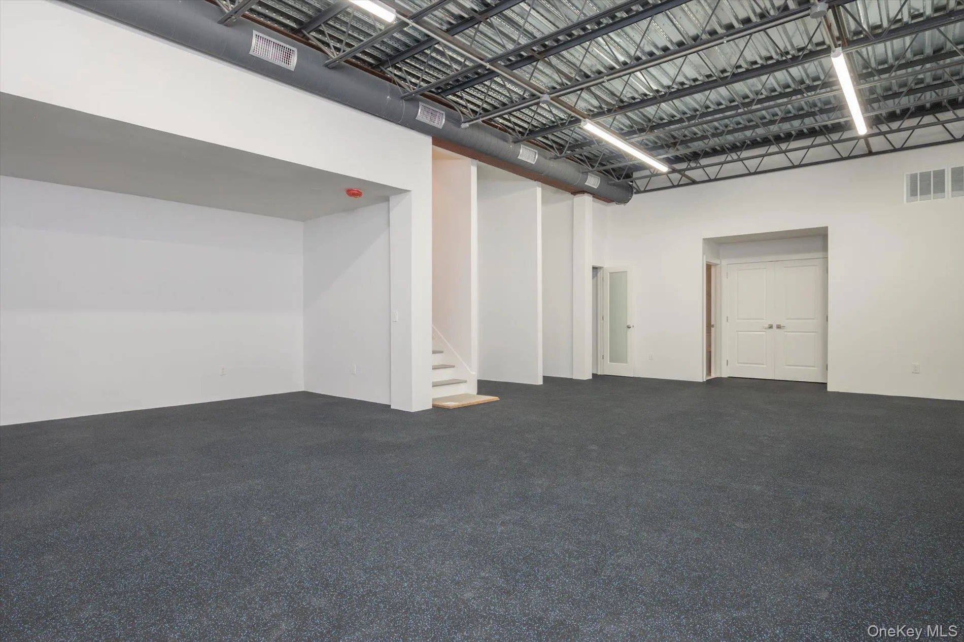 Fitness room/gym with his and hers full baths plus storage Fitness room/gym with his and hers full baths plus storage