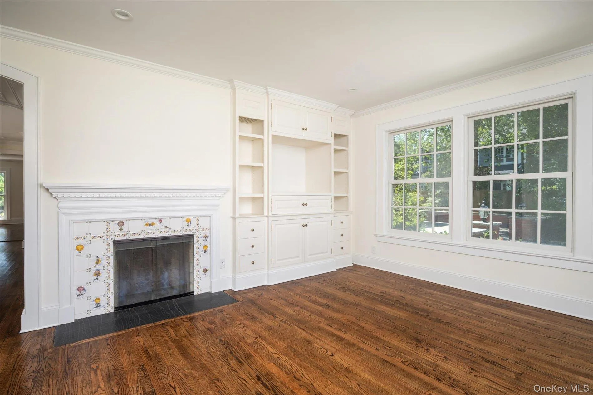 Main level den with wood burning fireplace and built in shelving Main level den with wood burning fireplace and built in shelving