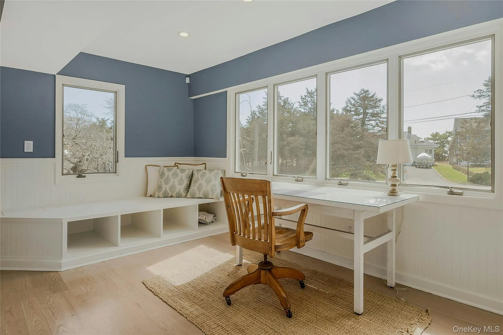 Home office with wainscoting and wood finished floors Home office with wainscoting and wood finished floors