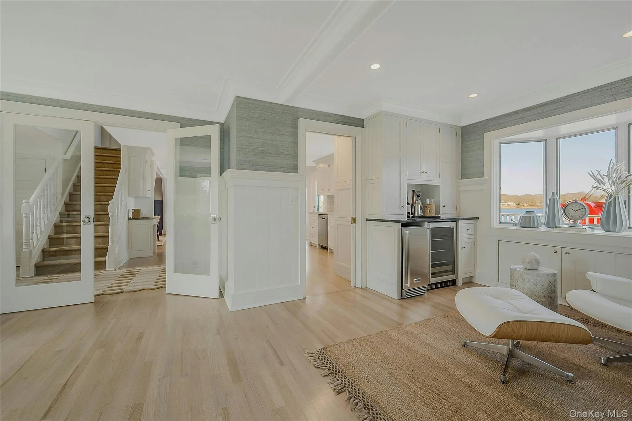 Kitchen with ornamental molding, wine cooler, and light wood finished floors Kitchen with ornamental molding, wine cooler, and light wood finished floors