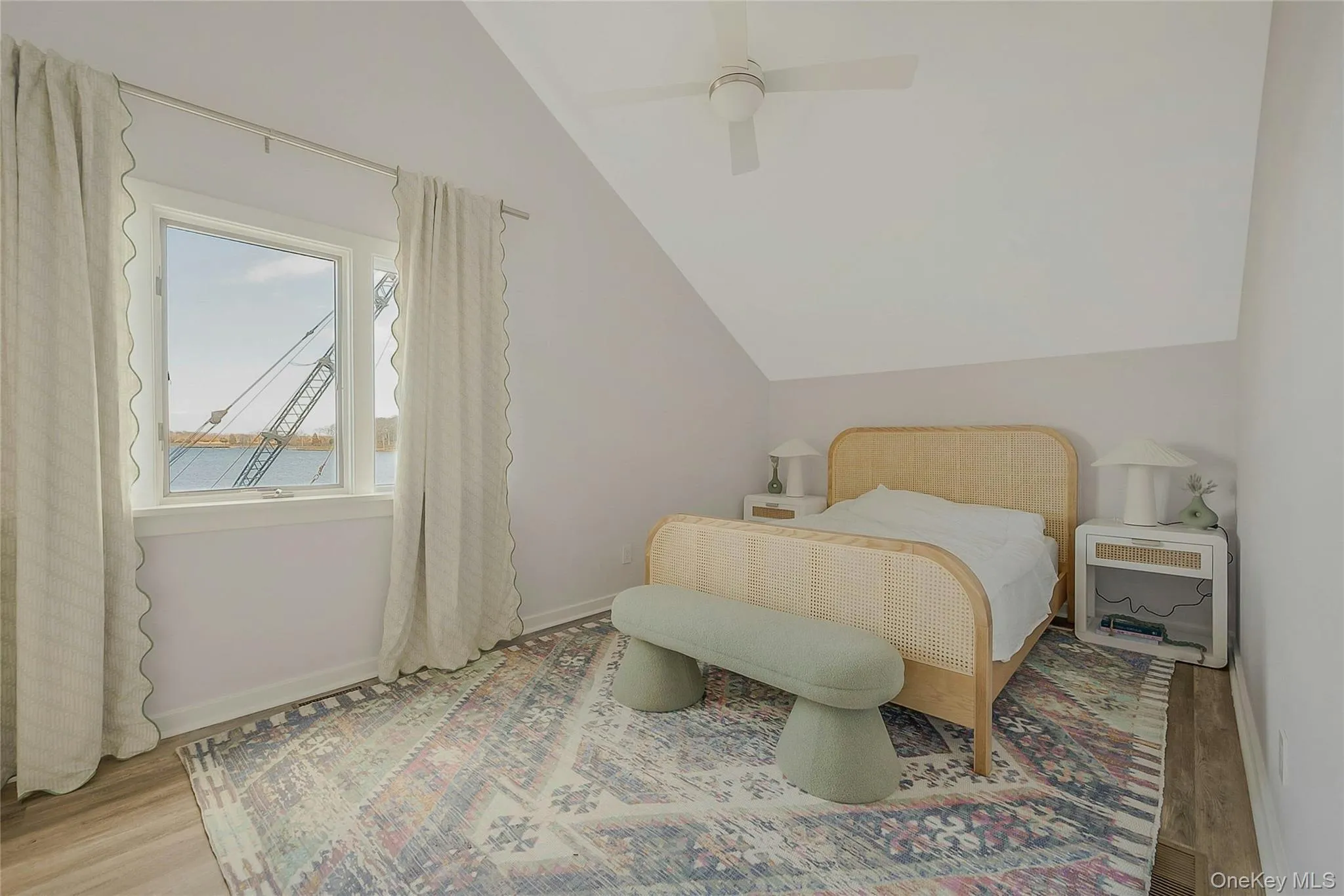Bedroom featuring baseboards, vaulted ceiling, visible vents, and wood finished floors Bedroom featuring baseboards, vaulted ceiling, visible vents, and wood finished floors