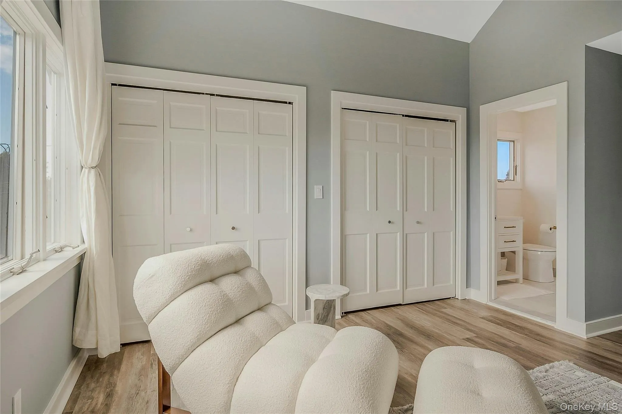 Living area featuring light wood-style flooring and baseboards Living area featuring light wood-style flooring and baseboards