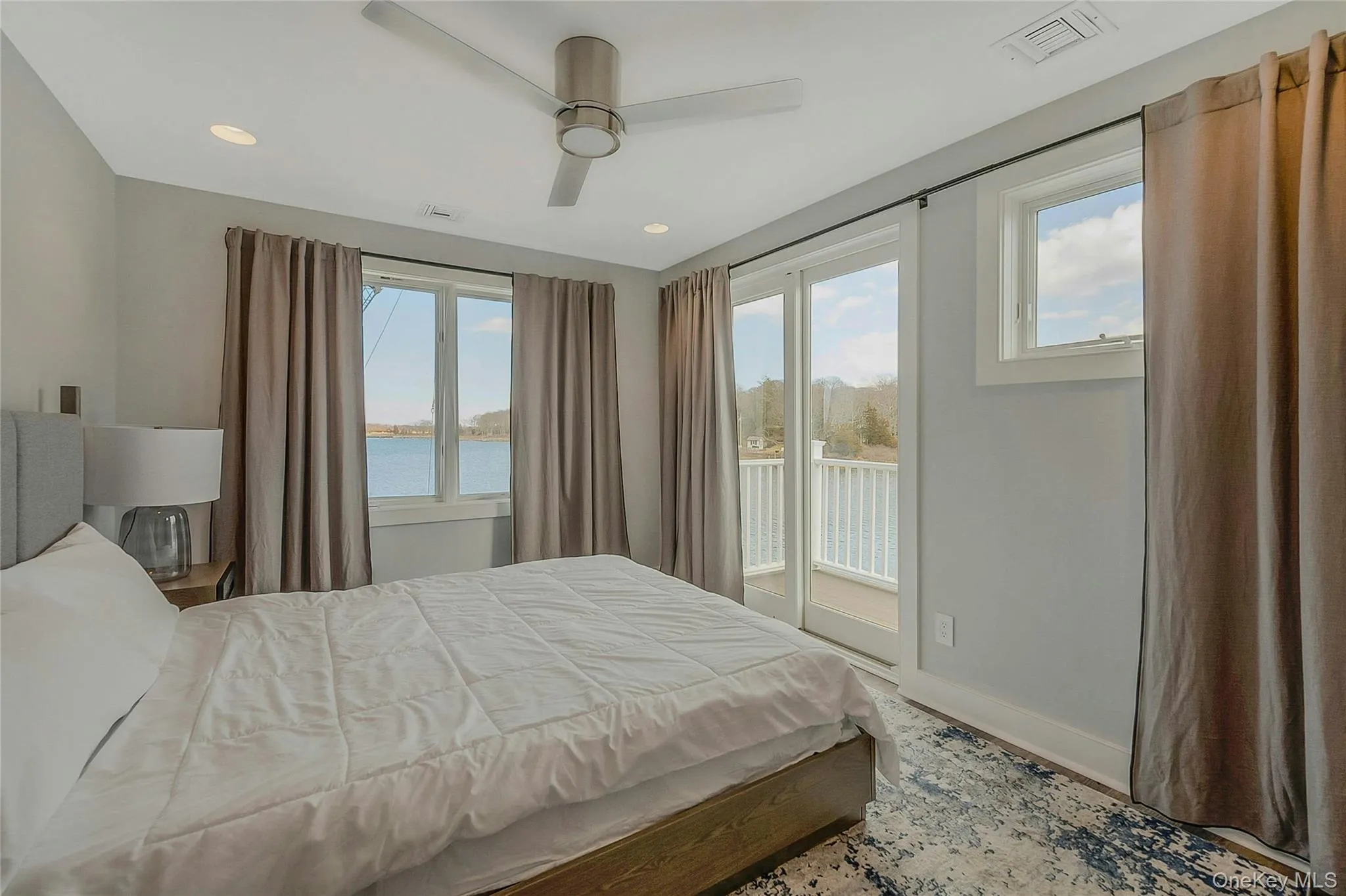 Bedroom with access to outside, baseboards, visible vents, a water view, and recessed lighting Bedroom with access to outside, baseboards, visible vents, a water view, and recessed lighting
