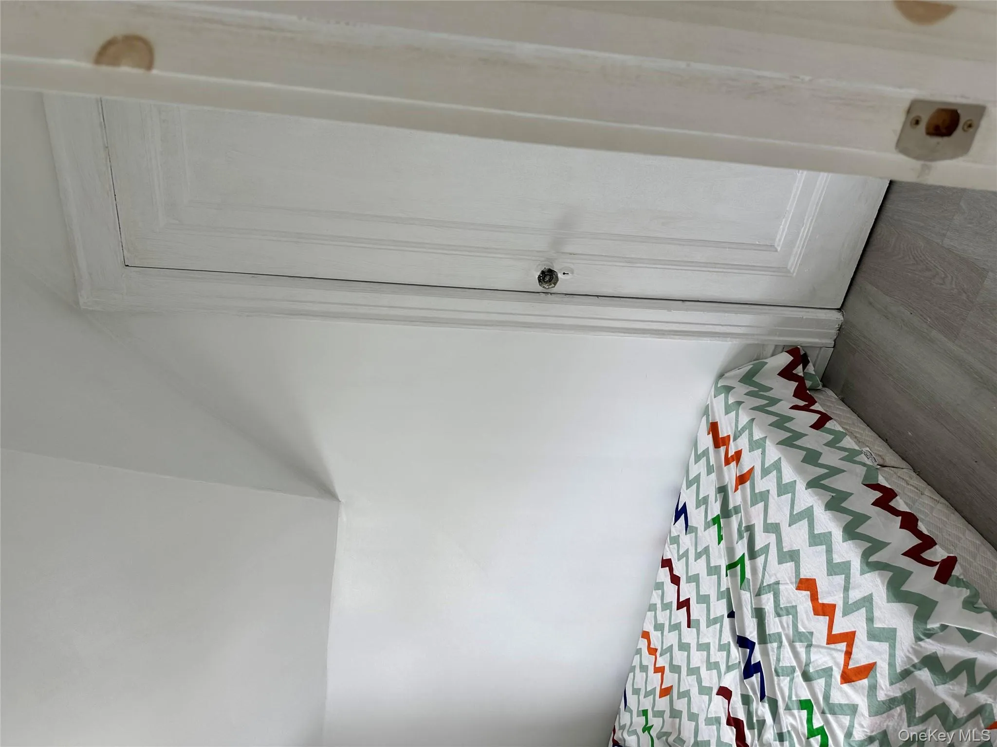Bedroom featuring wood finished floors and lofted ceiling Bedroom featuring wood finished floors and lofted ceiling