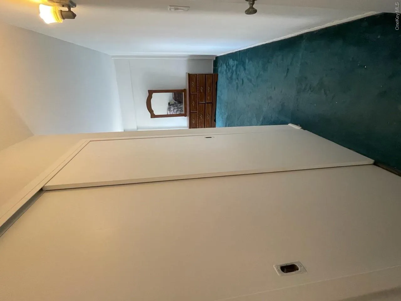 Hallway with baseboards and dark carpet Hallway with baseboards and dark carpet