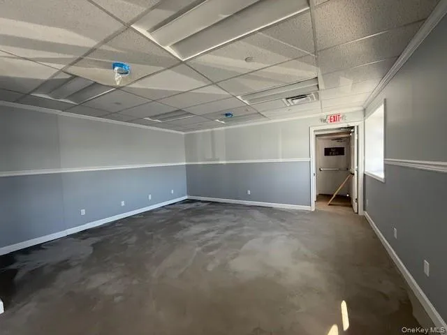 Unfurnished room Plank flooring to be installed baseboards, visible vents, and a paneled ceiling Unfurnished room Plank flooring to be installed baseboards, visible vents, and a paneled ceiling