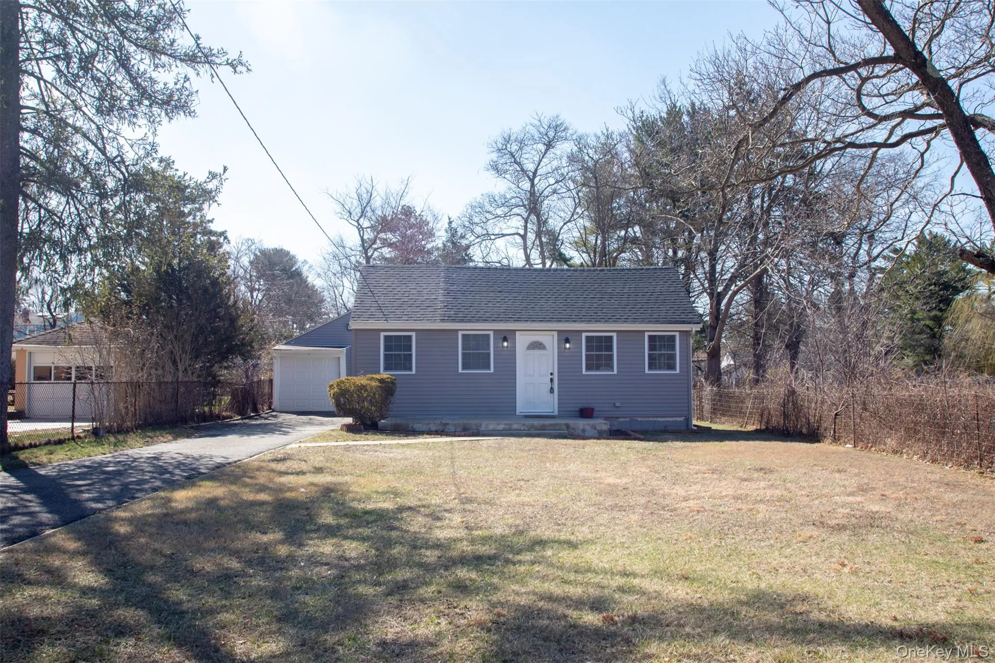 Single story home with a front yard, roof with shingles, fence, aphalt driveway, and a garage Single story home with a front yard, roof with shingles, fence, aphalt driveway, and a garage