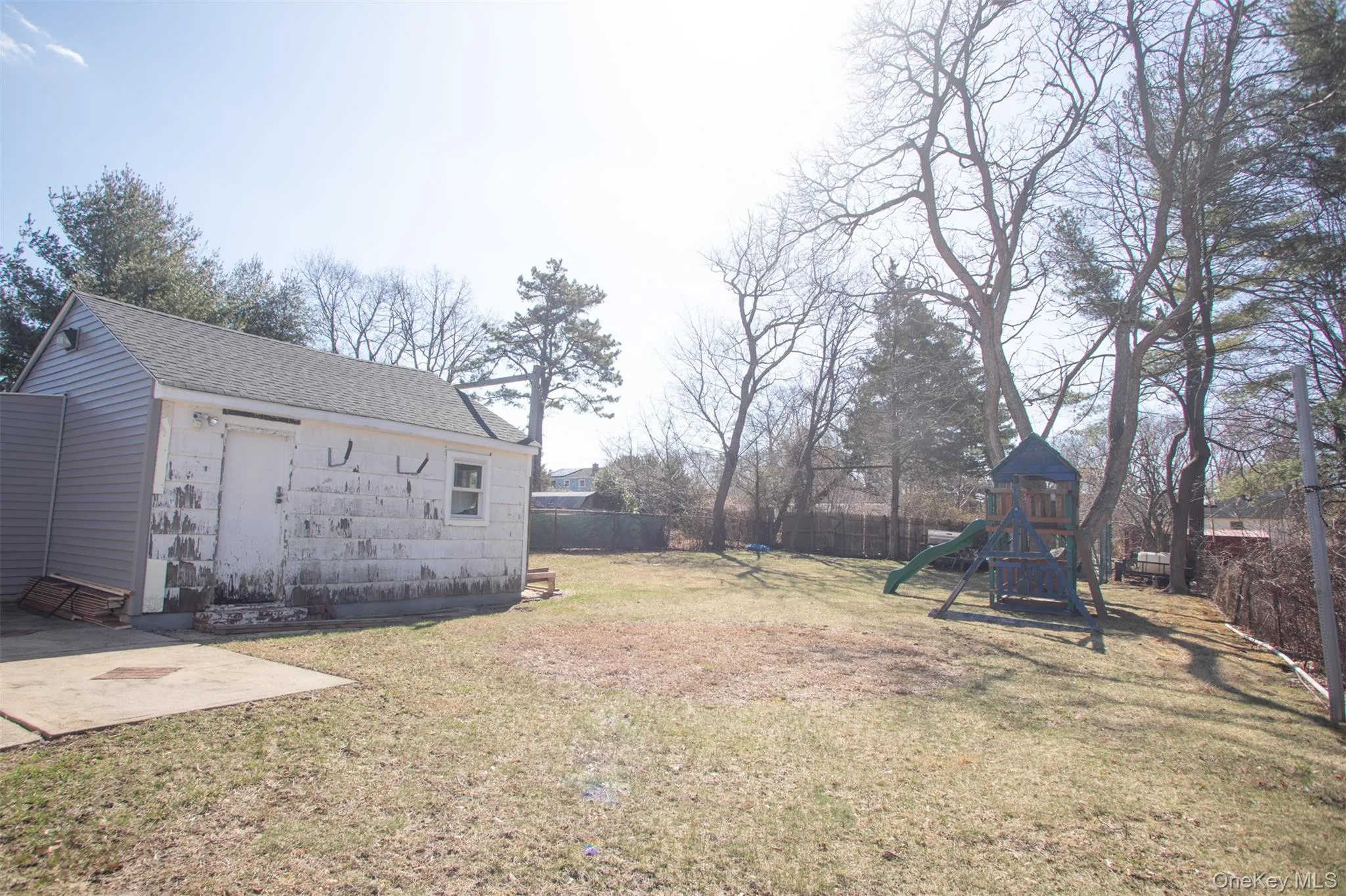 View of yard with a patio area, fence, and a playground View of yard with a patio area, fence, and a playground