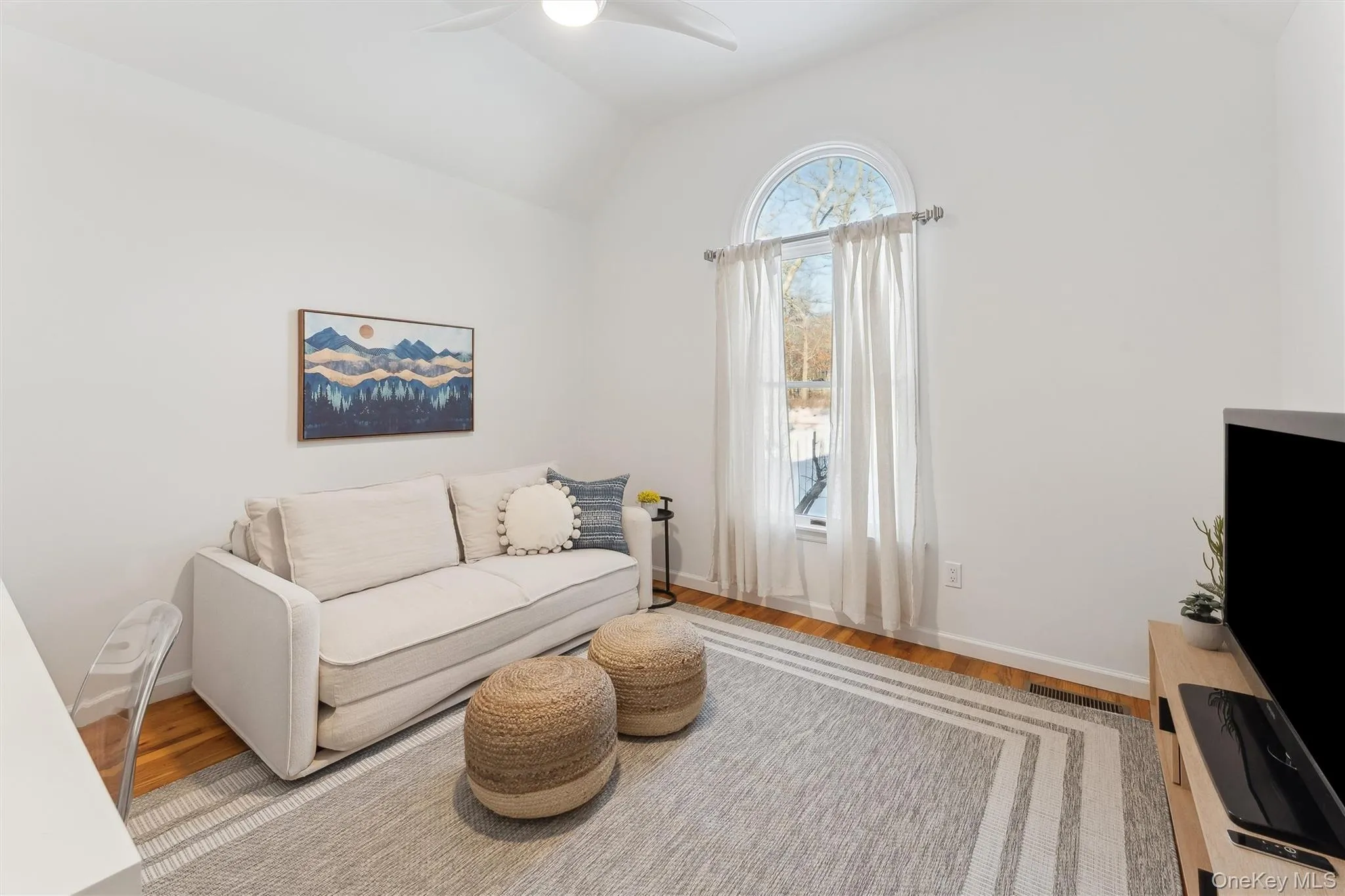 Living area featuring wood finished floors,   and ceiling fan Living area featuring wood finished floors,   and ceiling fan