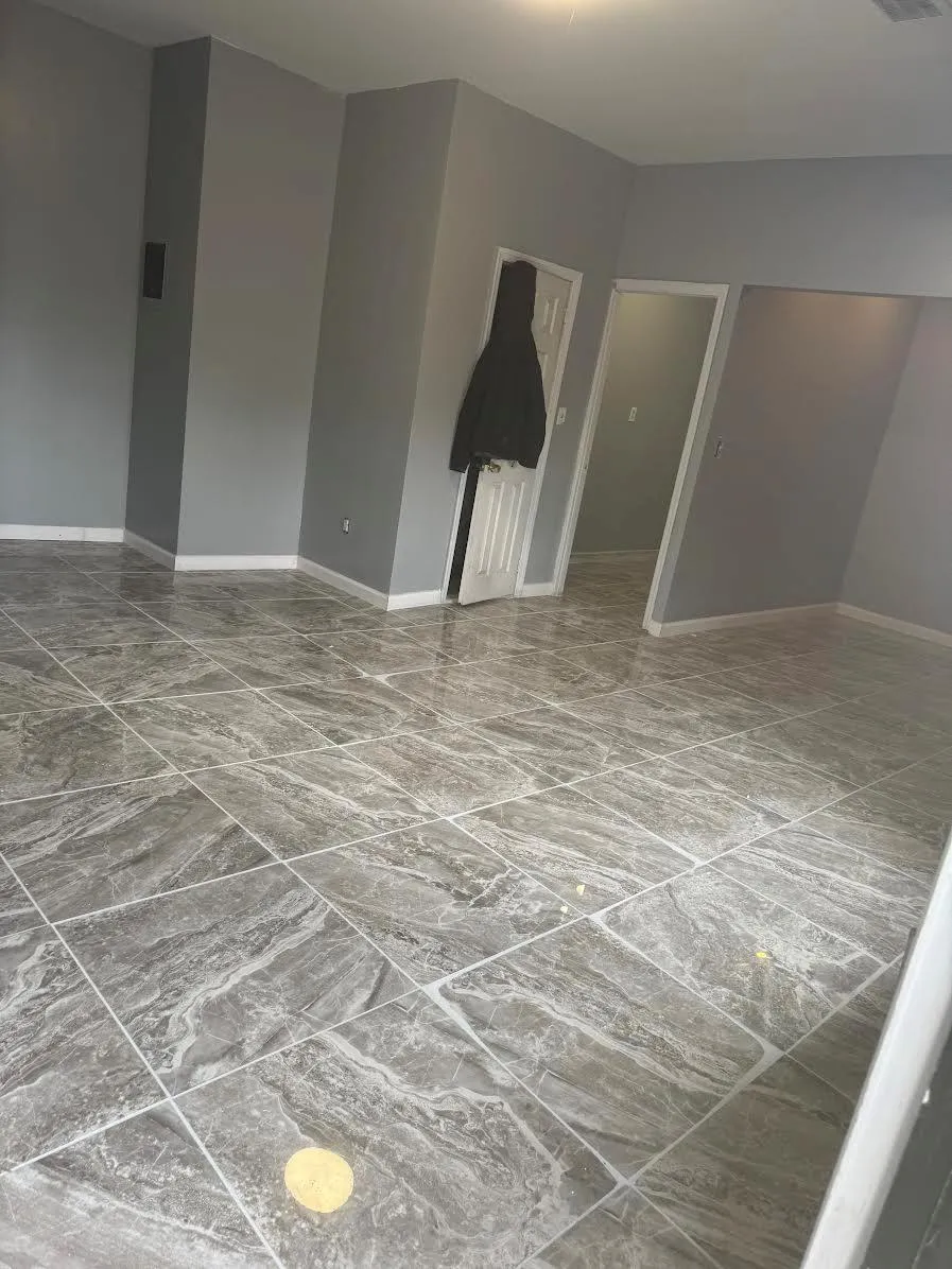 Spare room featuring marble finish floor and baseboards Spare room featuring marble finish floor and baseboards