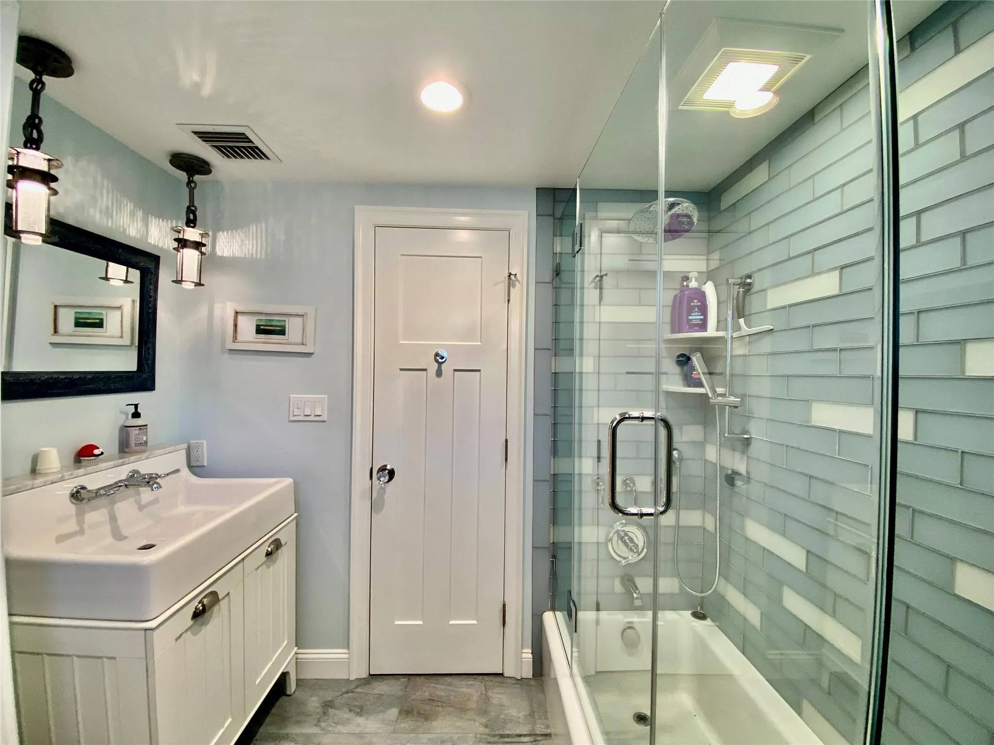 Bathroom featuring bath / shower combo with glass door, and vanity Bathroom featuring bath / shower combo with glass door, and vanity