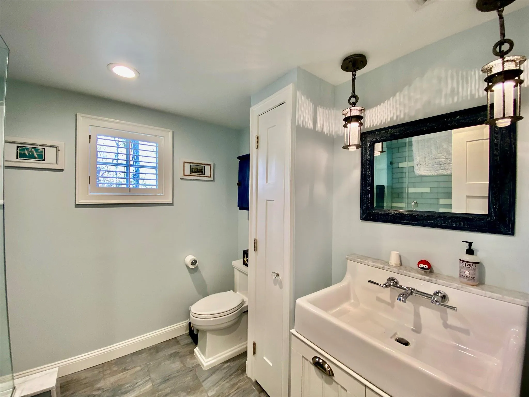 Bathroom featuring toilet, a shower, and vanity Bathroom featuring toilet, a shower, and vanity