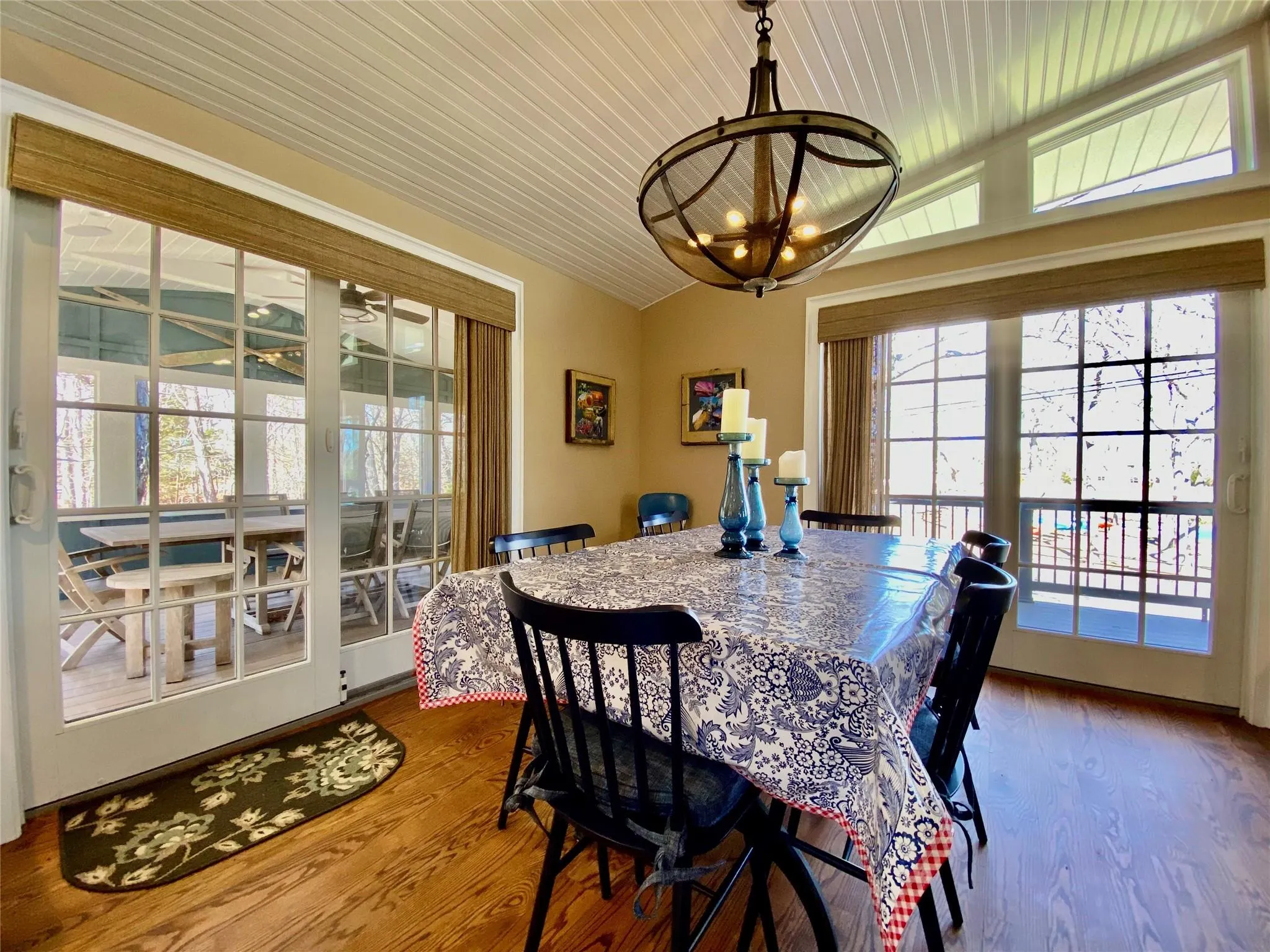 Dining area with vaulted ceiling, wood finished floors, wood ceiling, and an inviting chandelier Dining area with vaulted ceiling, wood finished floors, wood ceiling, and an inviting chandelier