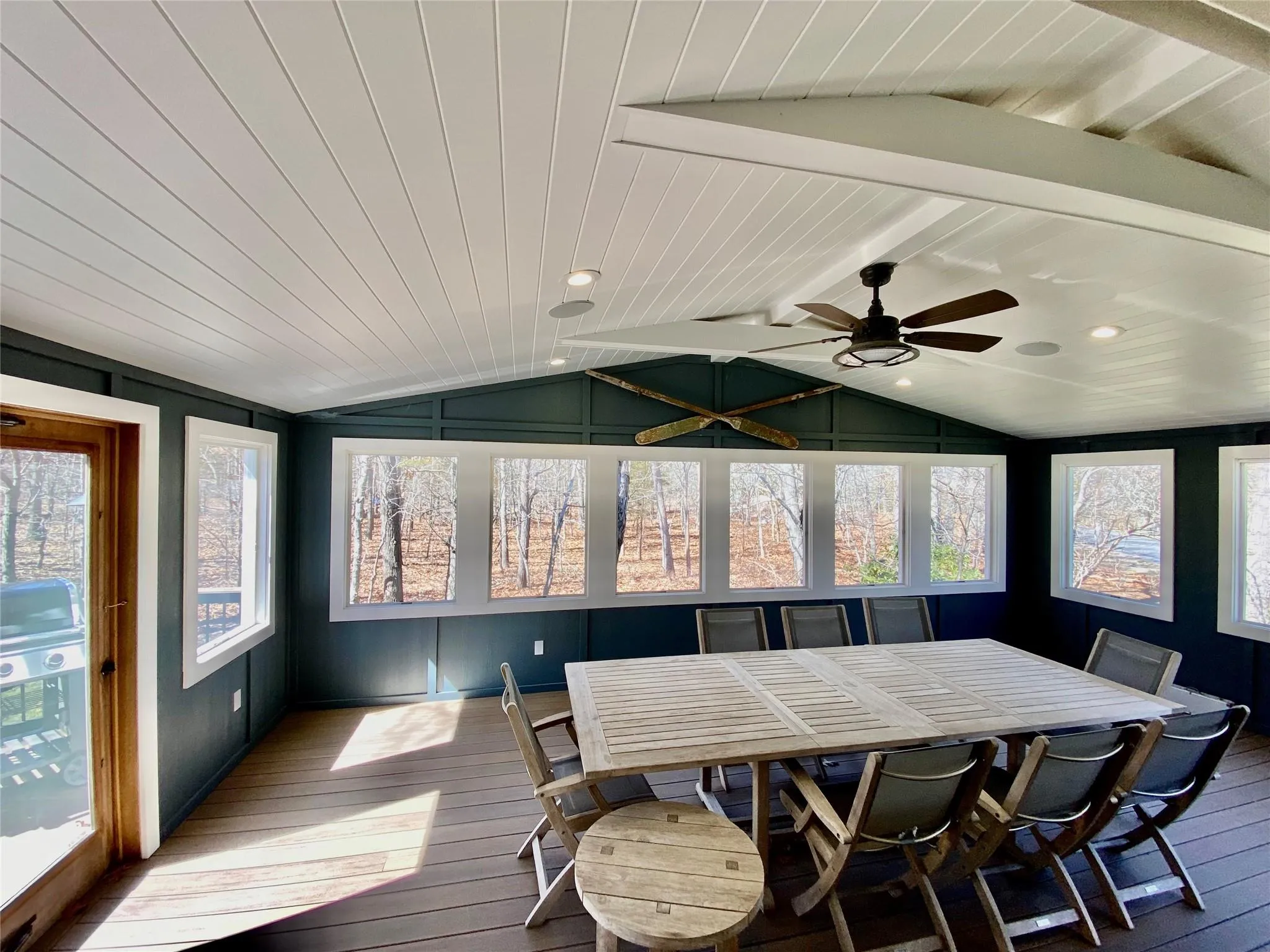 Sunroom with vaulted ceiling with beams and hardwood / wood-style flooring Sunroom with vaulted ceiling with beams and hardwood / wood-style flooring