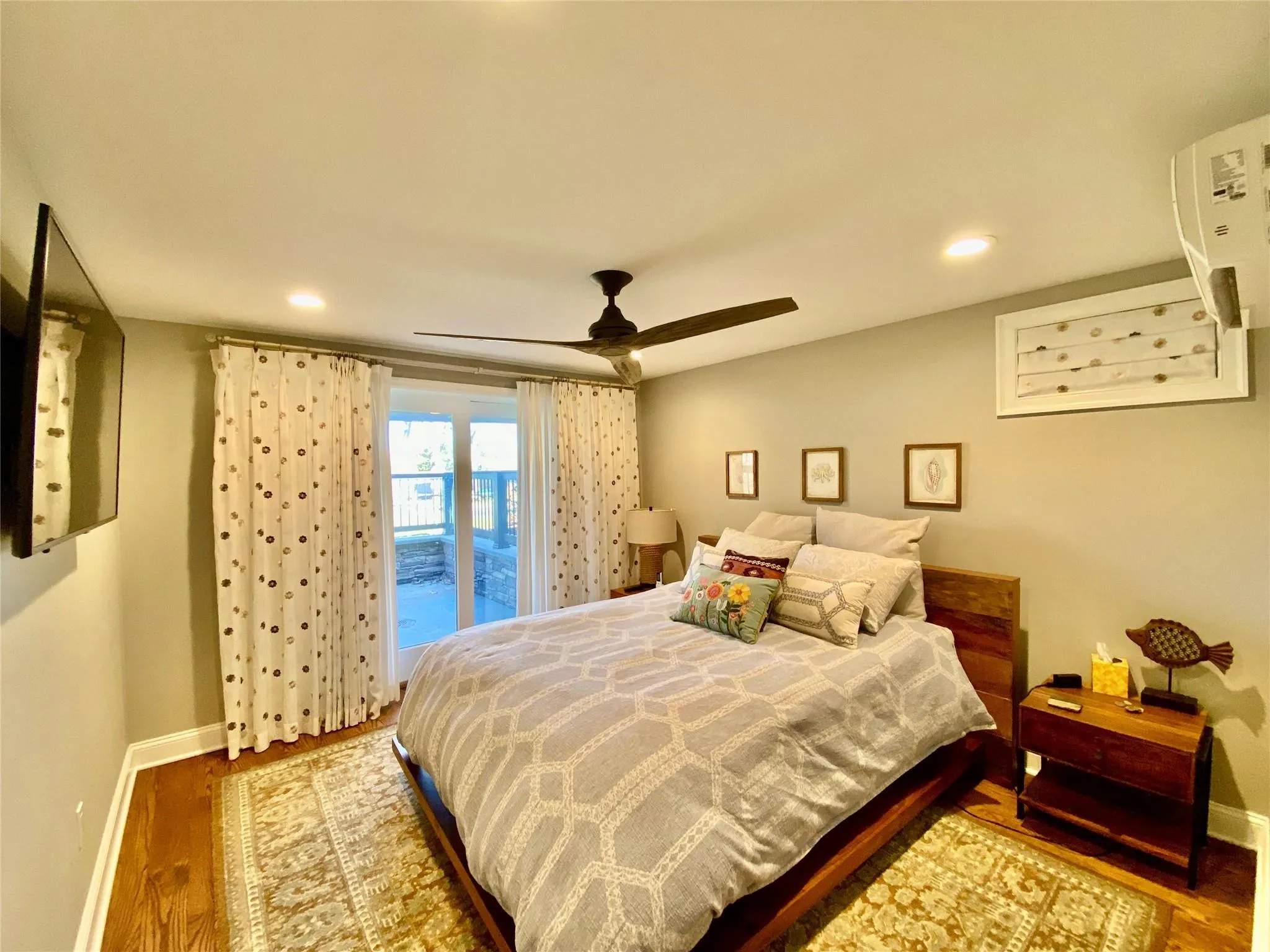 Bedroom featuring a ceiling fan, recessed lighting and wood finished floors Bedroom featuring a ceiling fan, recessed lighting and wood finished floors