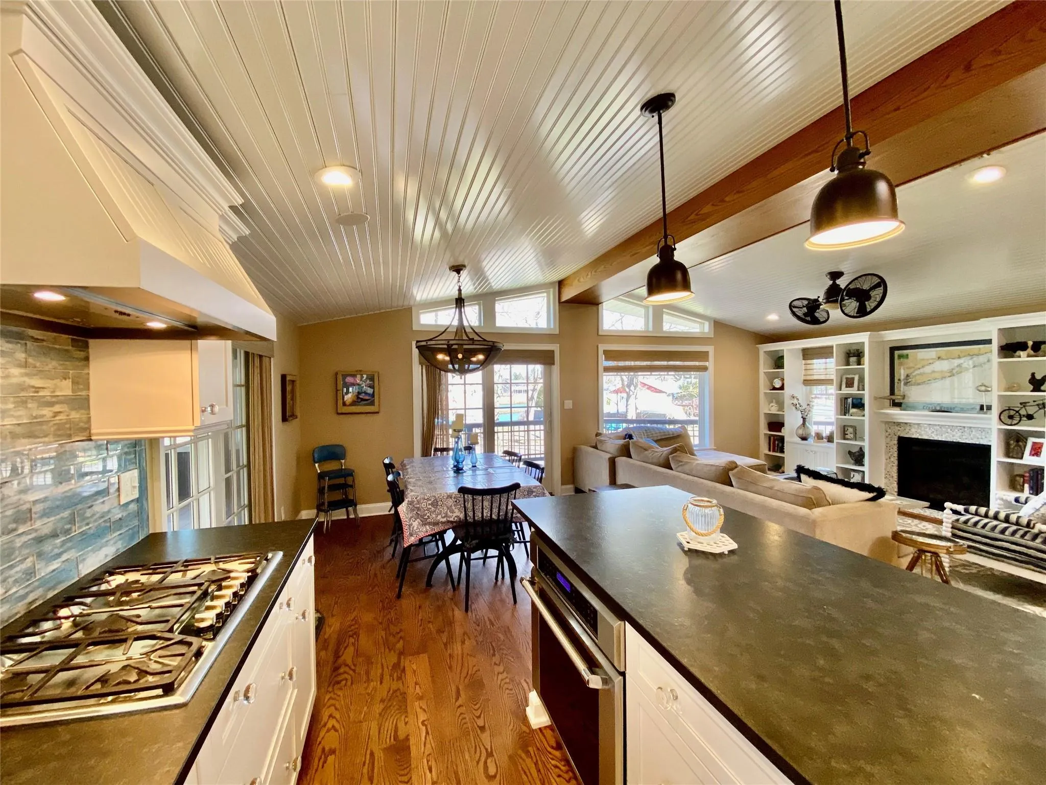 Kitchen with stone countertops, stainless steel gas stovetop, vaulted ceiling Kitchen with stone countertops, stainless steel gas stovetop, vaulted ceiling
