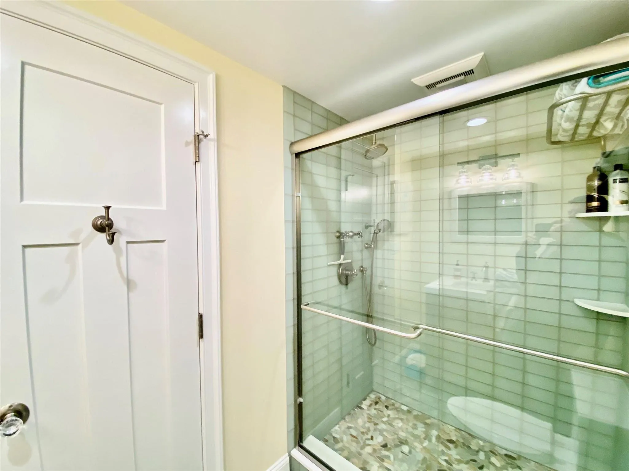 Full bathroom featuring visible vents and a stall shower Full bathroom featuring visible vents and a stall shower