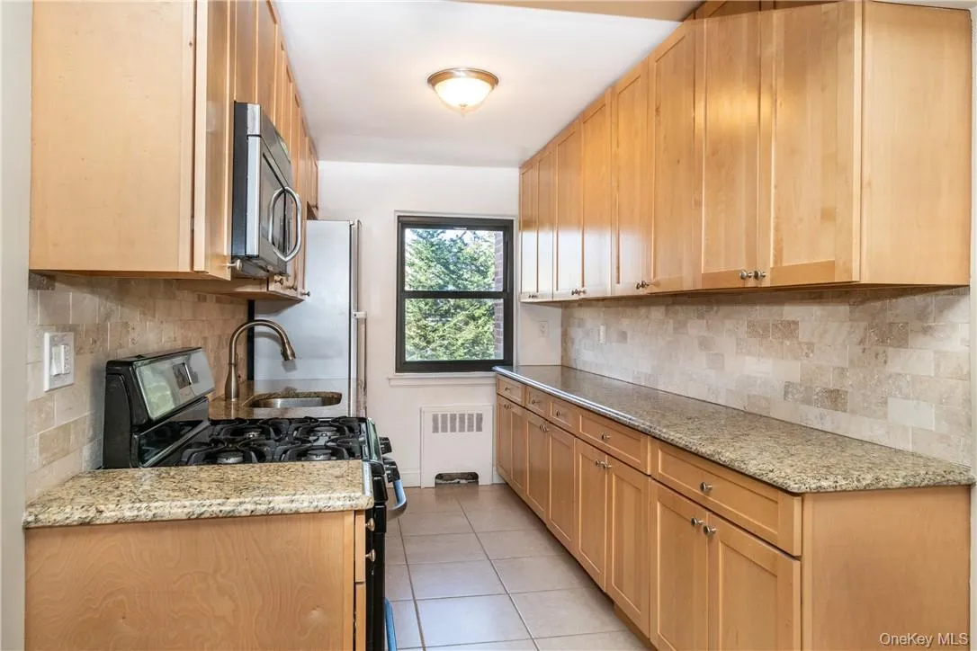 Large window completes this kitchen. Ample counter space. Large window completes this kitchen. Ample counter space.