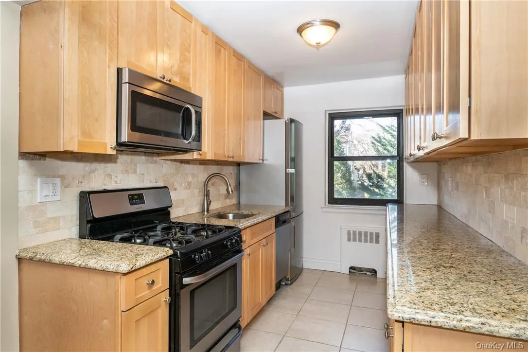 Updated kitchen with wood cabinets, stainless steel appliances, granite countertops and tile floor. Updated kitchen with wood cabinets, stainless steel appliances, granite countertops and tile floor.