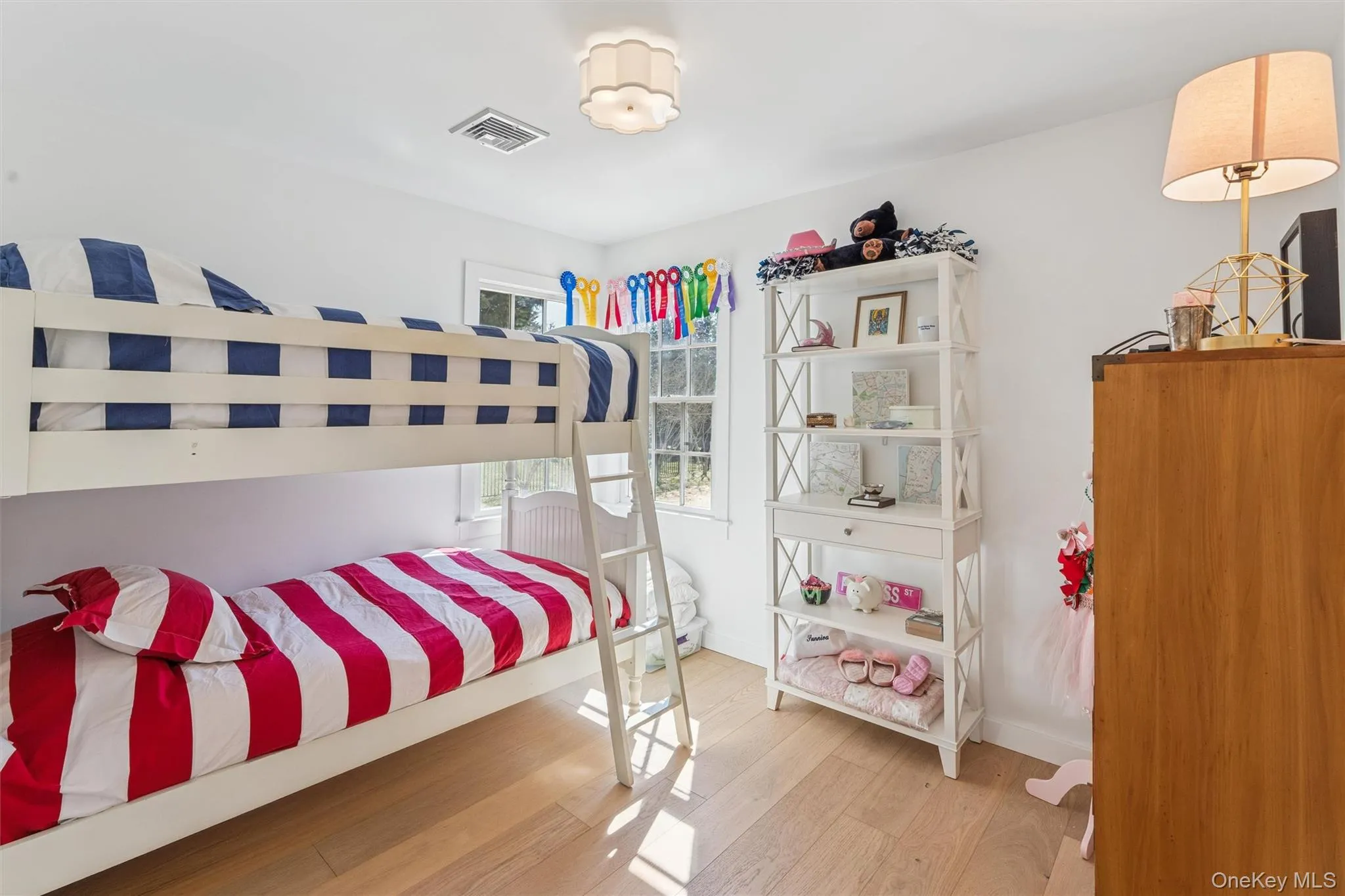 Bedroom with baseboards, visible vents, and light wood-style floors Bedroom with baseboards, visible vents, and light wood-style floors