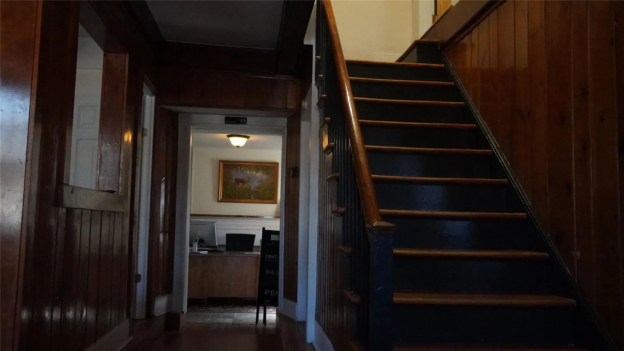 Stairway featuring wood walls Stairway featuring wood walls