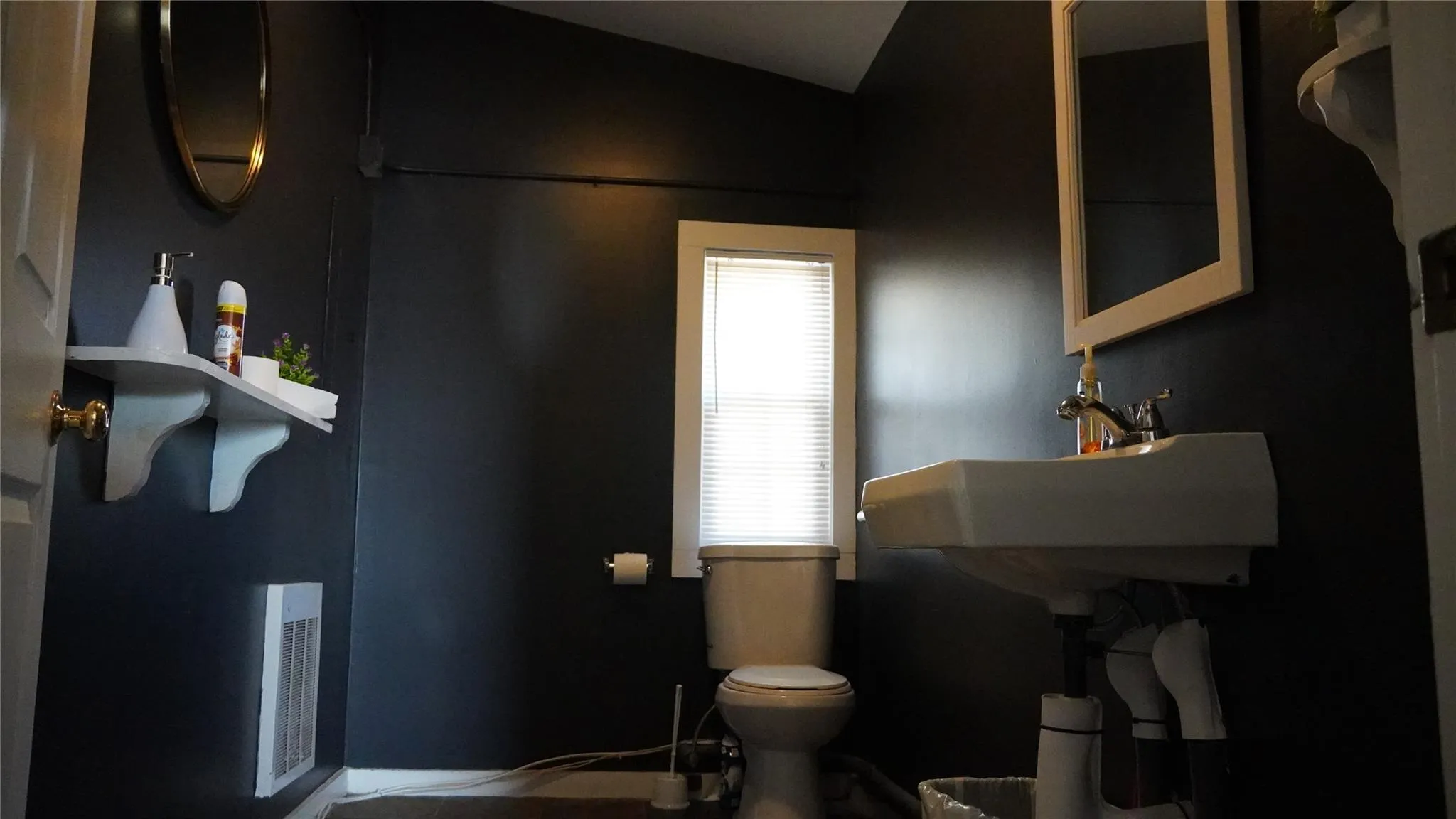 Bathroom with lofted ceiling, visible vents, and toilet Bathroom with lofted ceiling, visible vents, and toilet