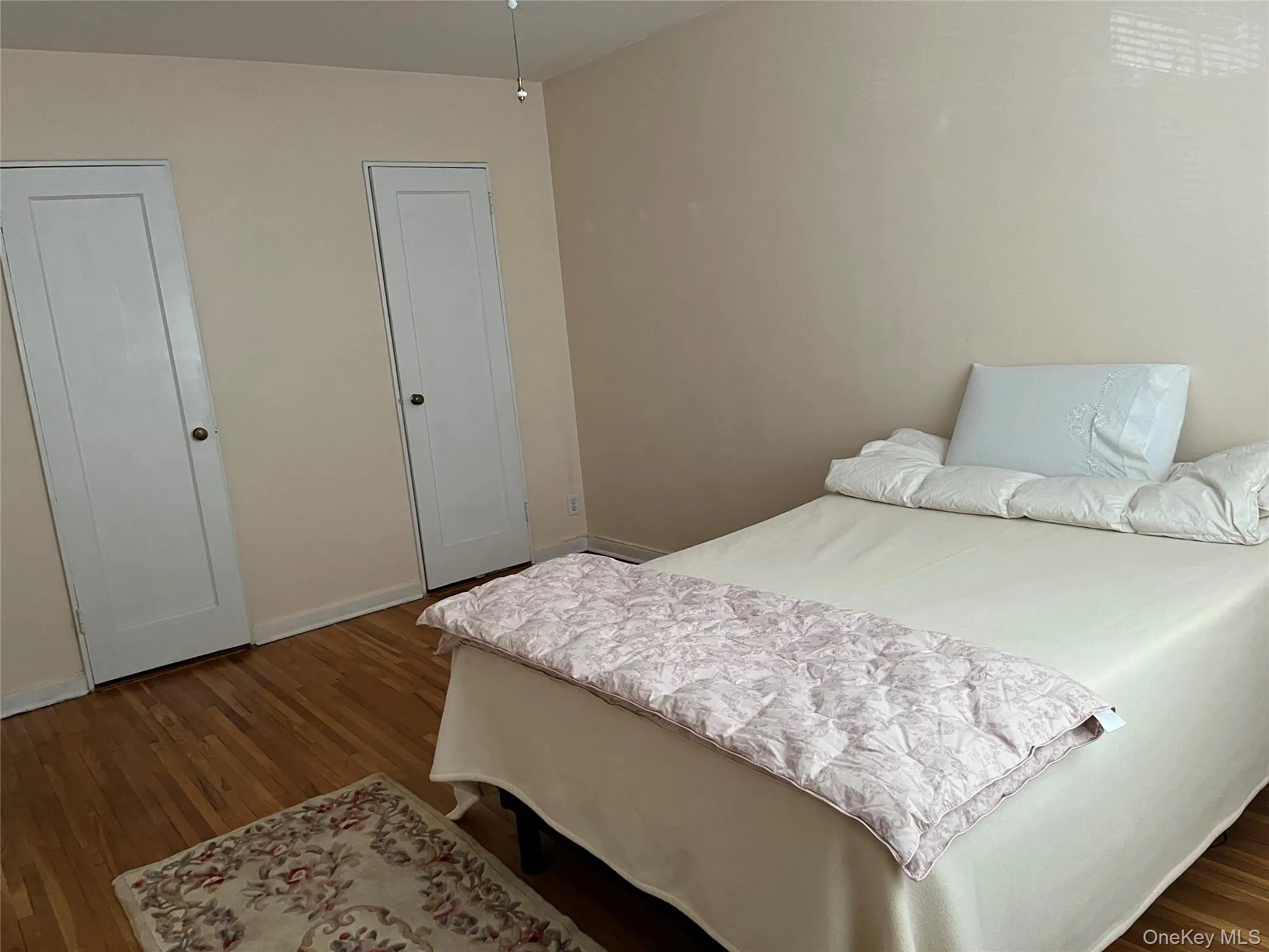 Larger Bedroom with baseboards and dark wood finished floors Larger Bedroom with baseboards and dark wood finished floors