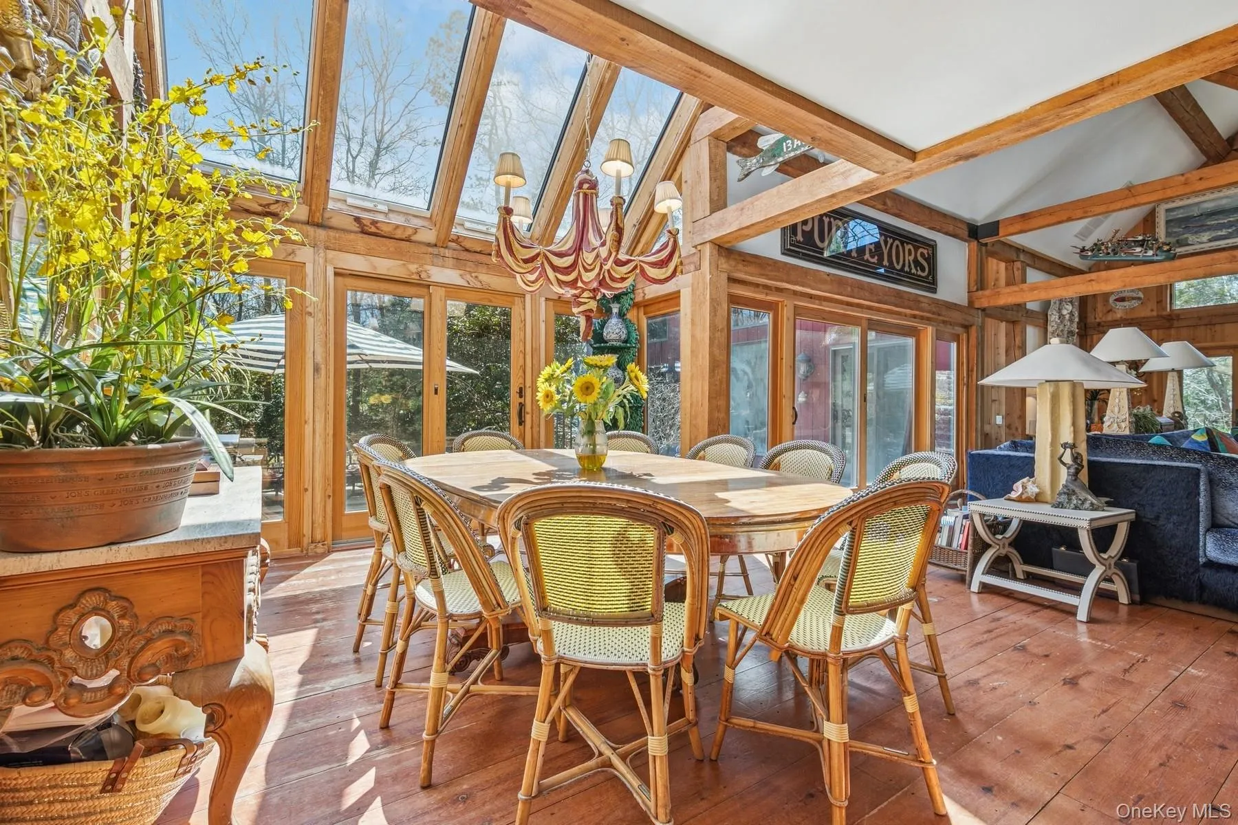 Sunroom / solarium featuring an inviting chandelier, a healthy amount of sunlight, and beamed ceiling Sunroom / solarium featuring an inviting chandelier, a healthy amount of sunlight, and beamed ceiling