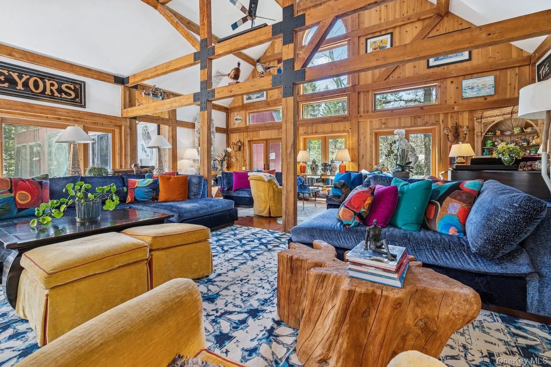 Living area with high vaulted ceiling, wood walls, and a healthy amount of sunlight Living area with high vaulted ceiling, wood walls, and a healthy amount of sunlight