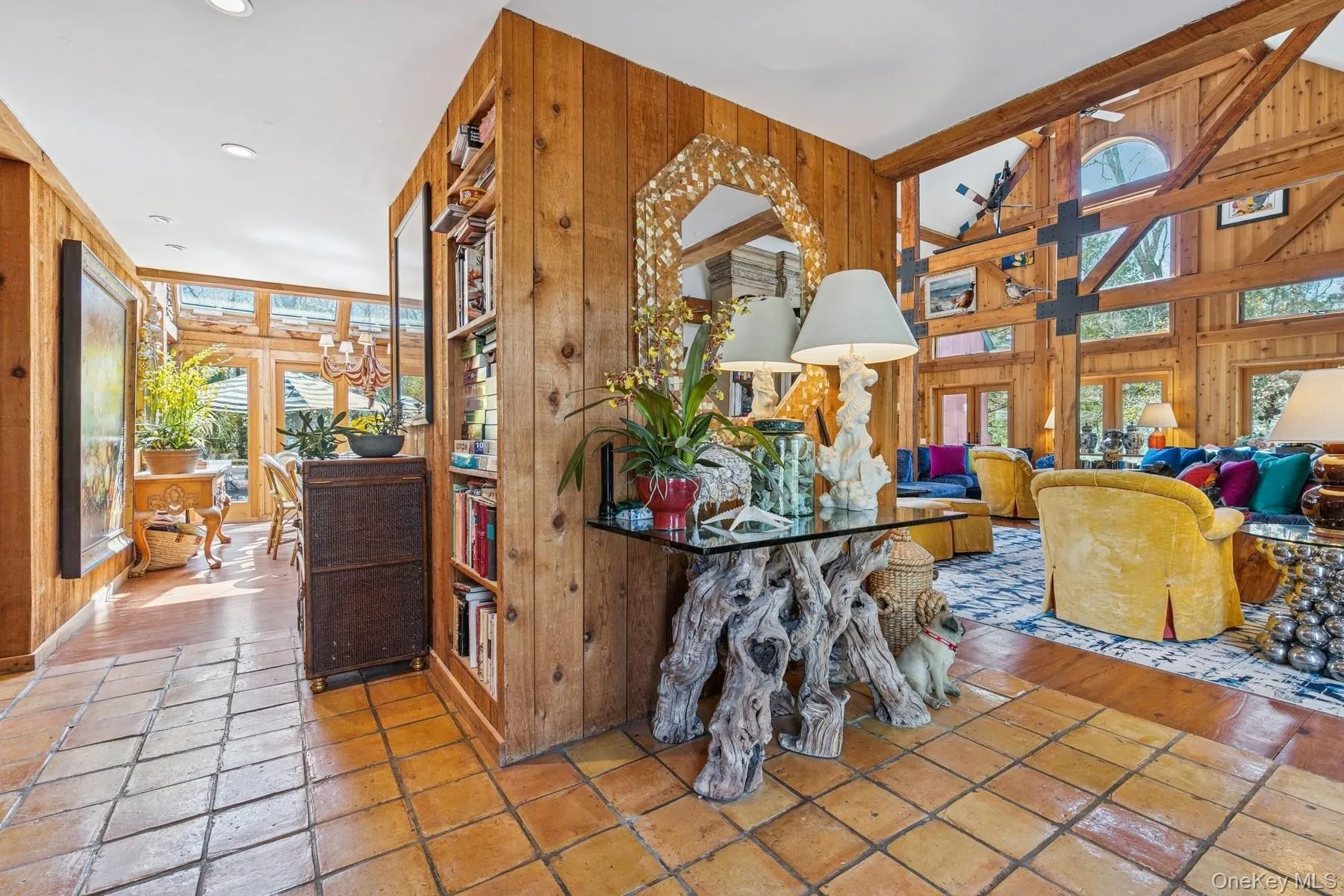 Sitting room featuring stone tile floors, wooden walls, french doors, lofted ceiling, and recessed lighting Sitting room featuring stone tile floors, wooden walls, french doors, lofted ceiling, and recessed lighting