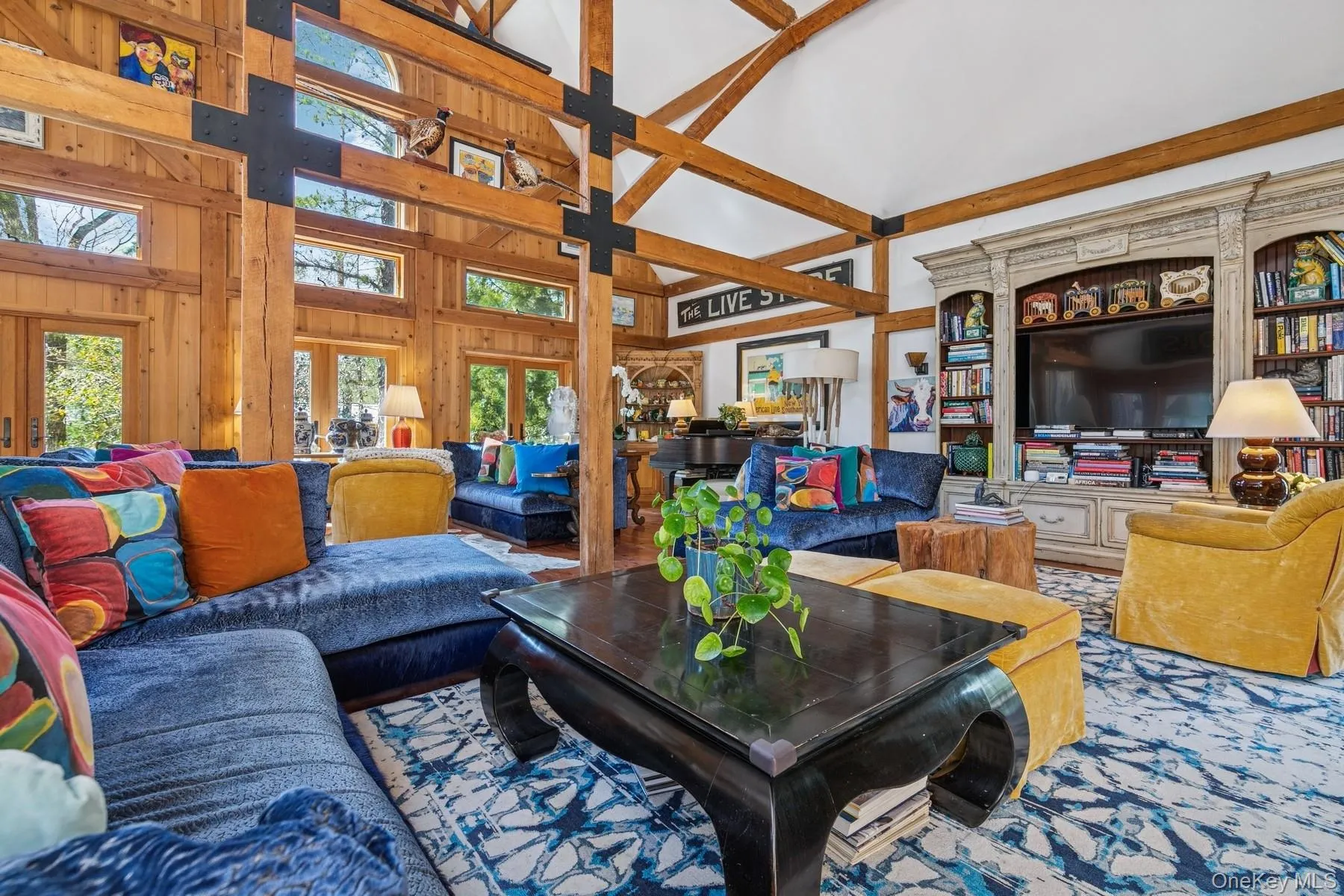 Living area with wooden walls and a high ceiling Living area with wooden walls and a high ceiling